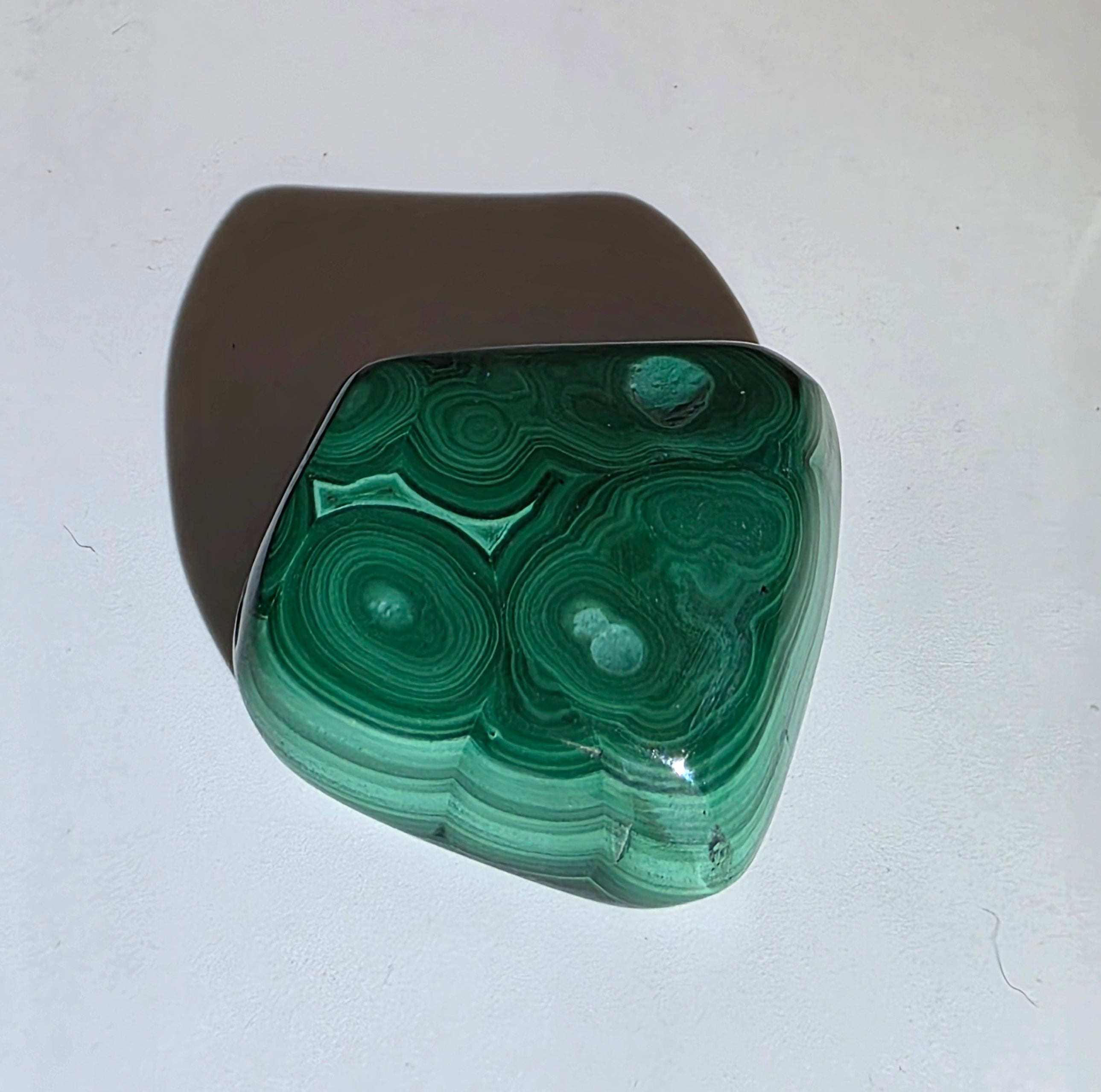 Green malachite stone on a white background