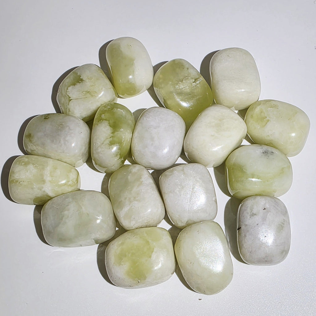 Collection of Jade tumble stones on a white background