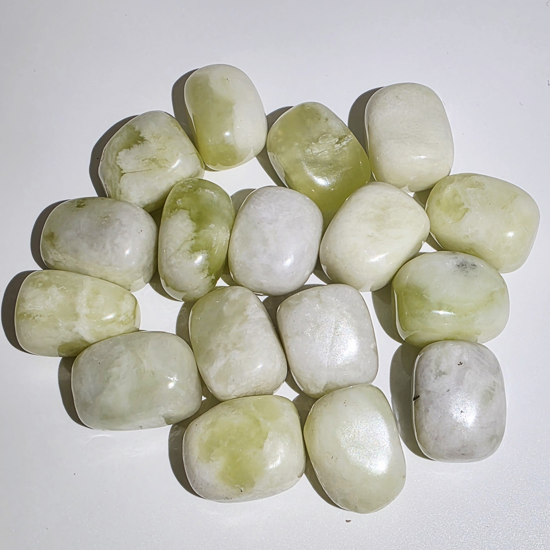 Collection of Jade tumble stones on a white background