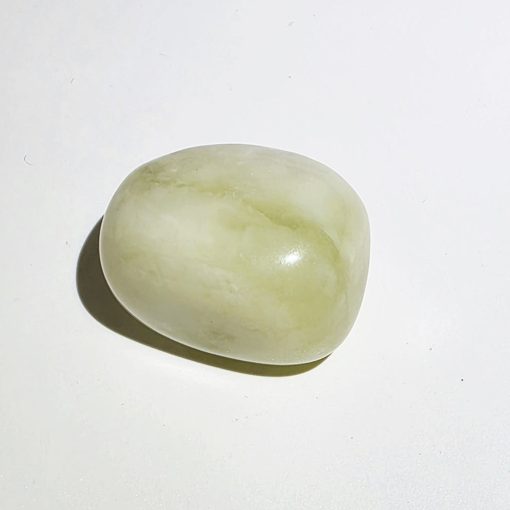 Jade tumble stone on a white background