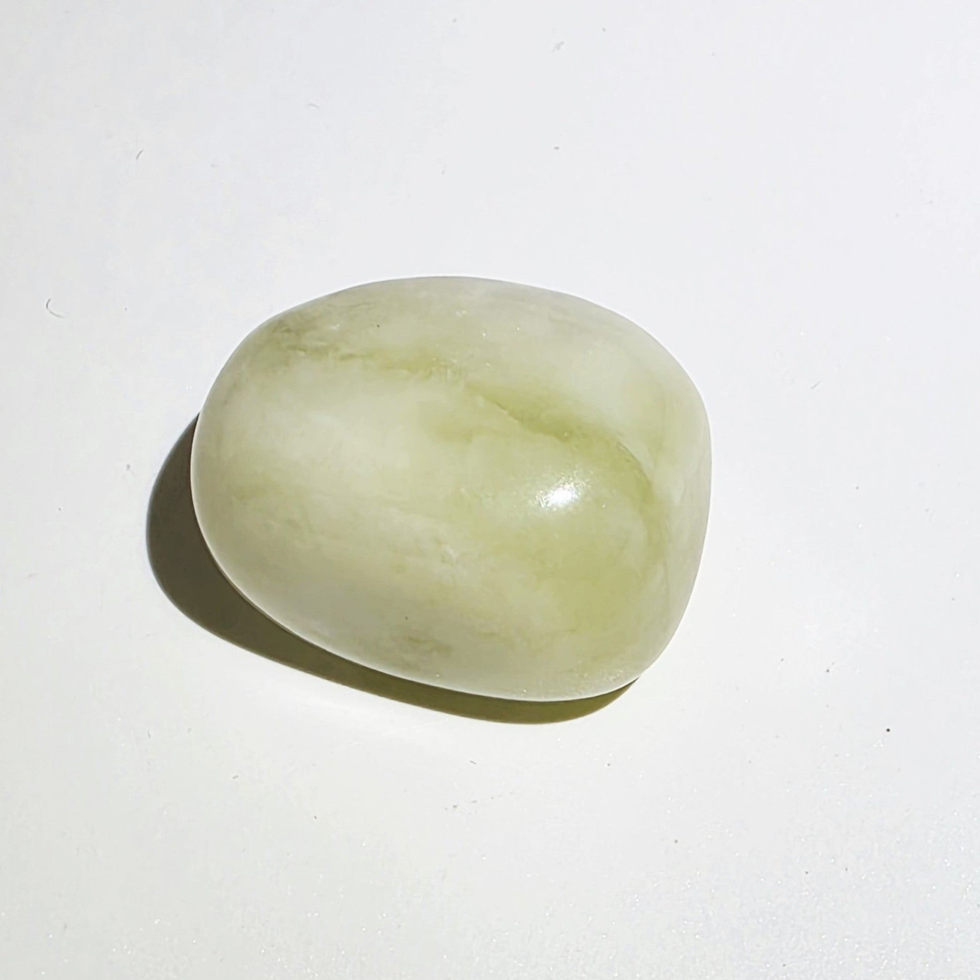 Jade tumble stone on a white background