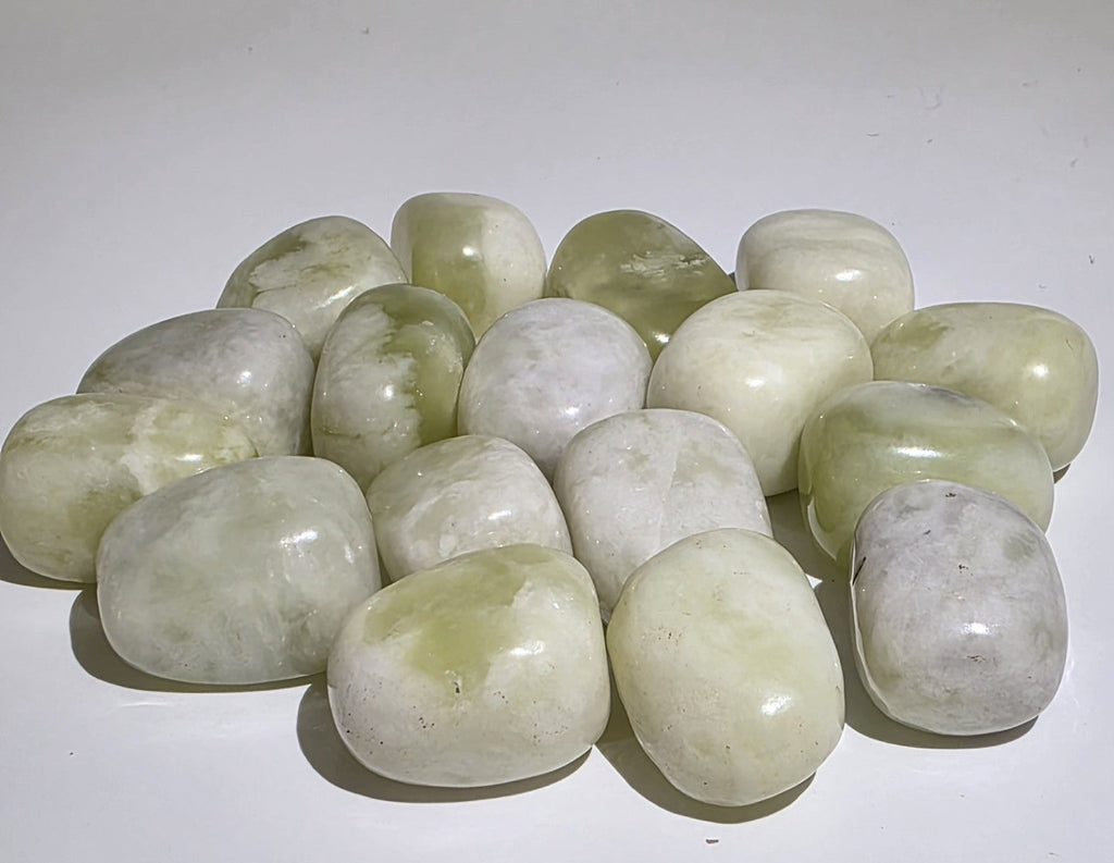 Collection of Jade stones on a white surface