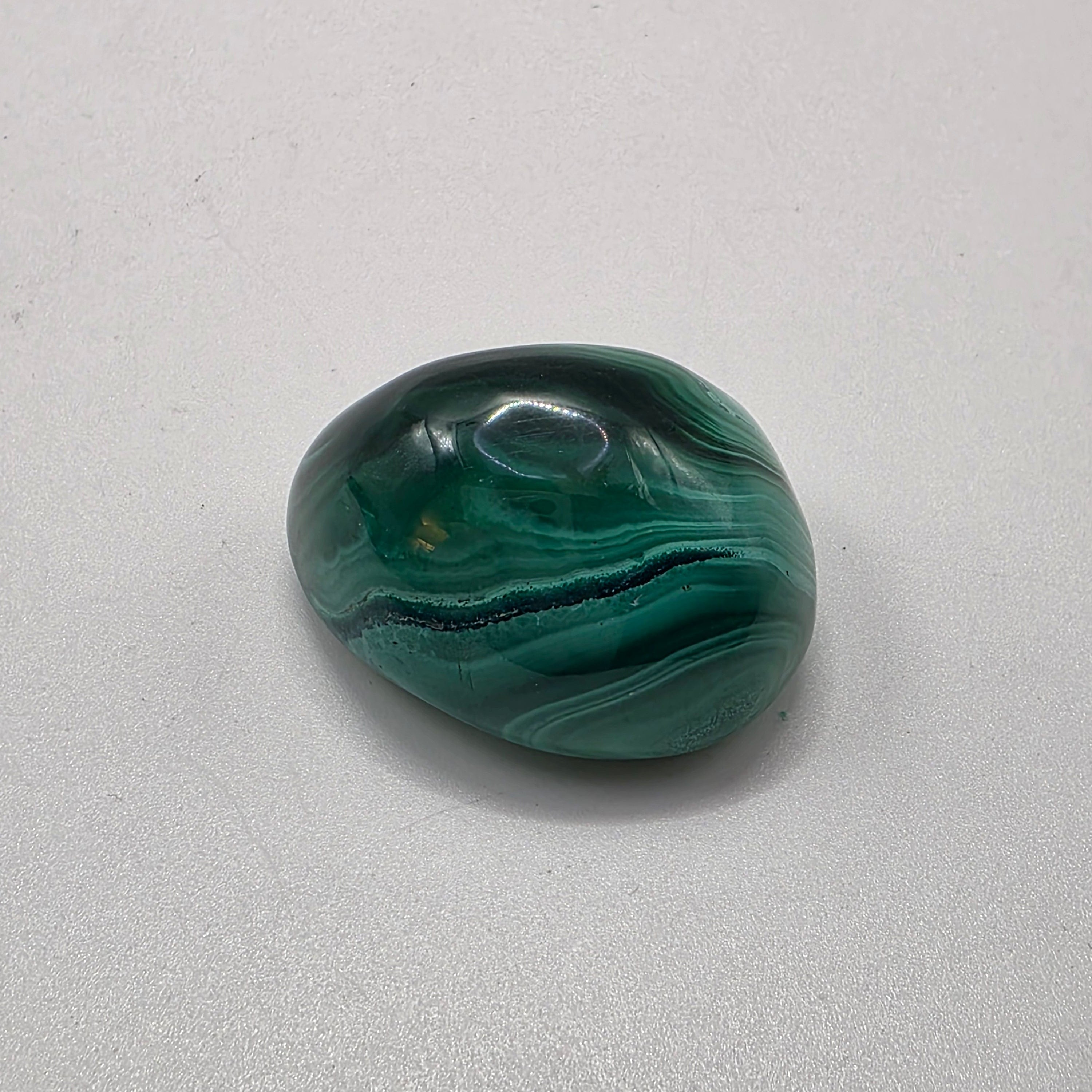 Single Malachite Crystal on a white background