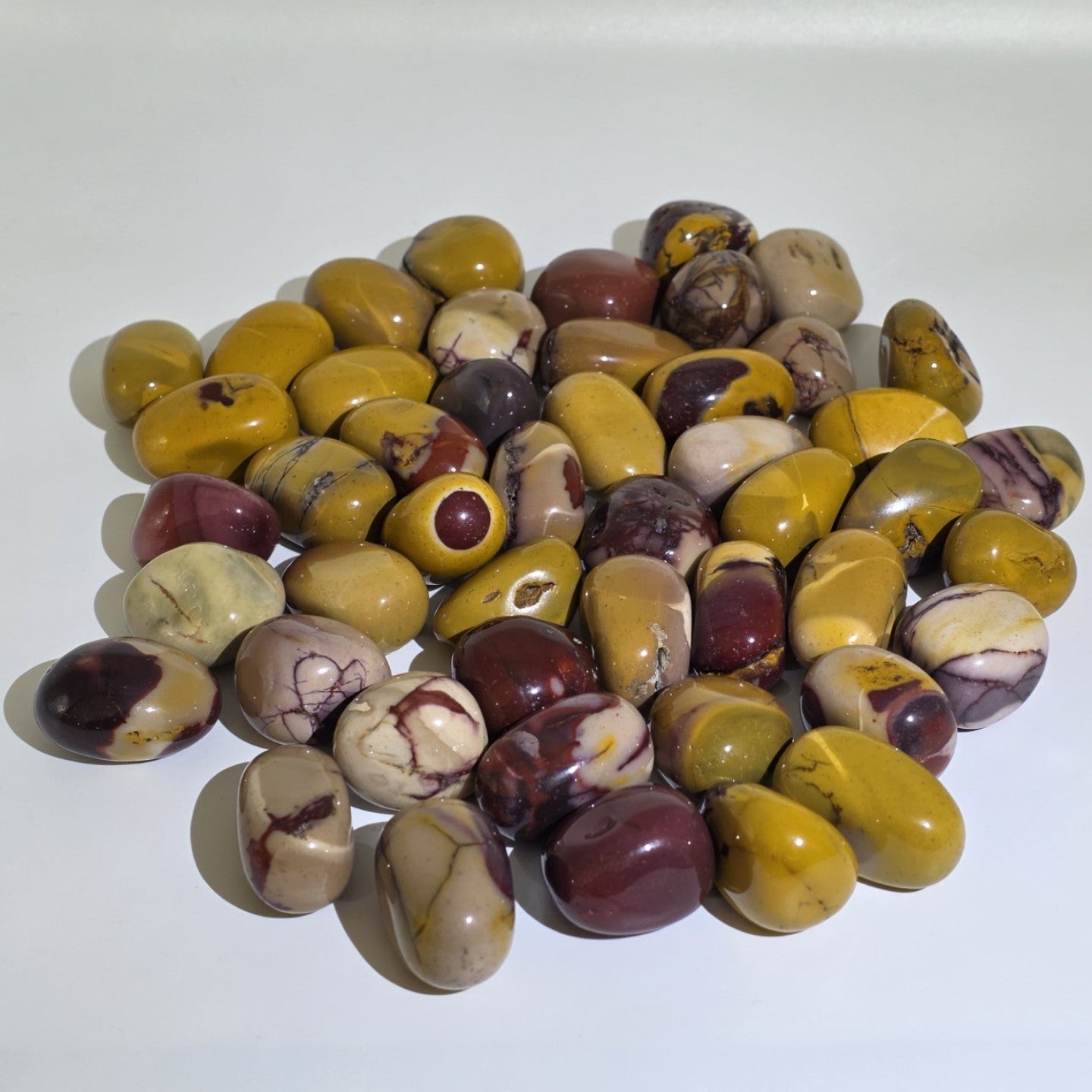 mookaite colored stones on a white background