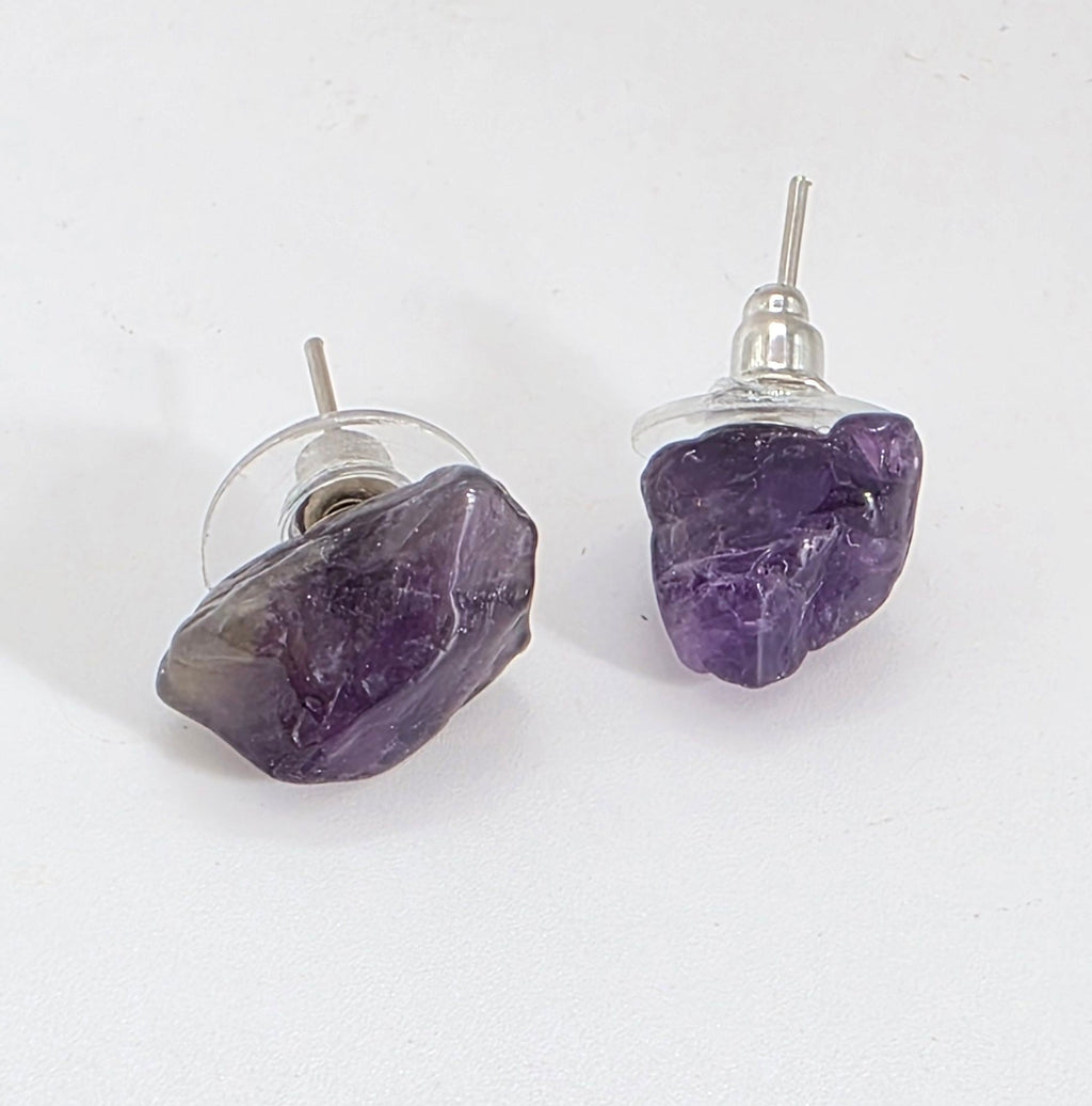 Pair of purple amethyst earrings on a white background