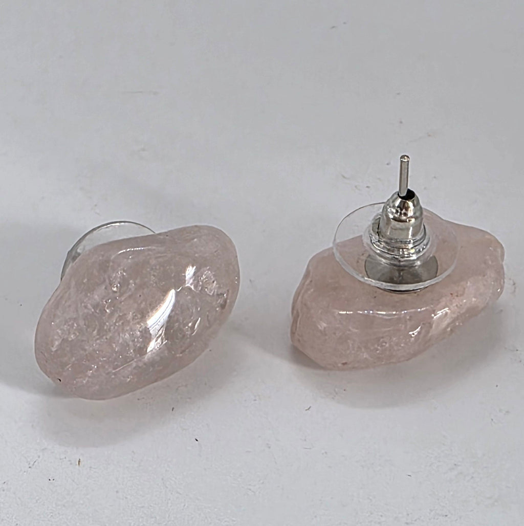Pair of earrings with rose quartz and silver base on a white background