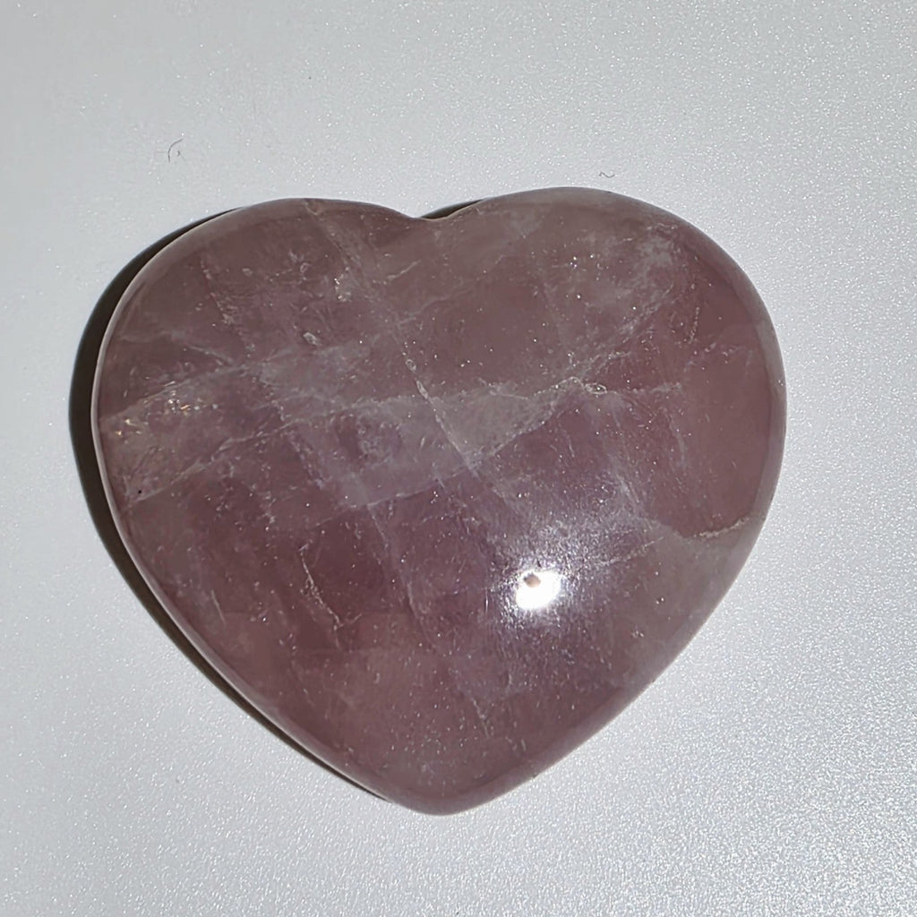 Heart-shaped Rose Quartz Crystal on white background