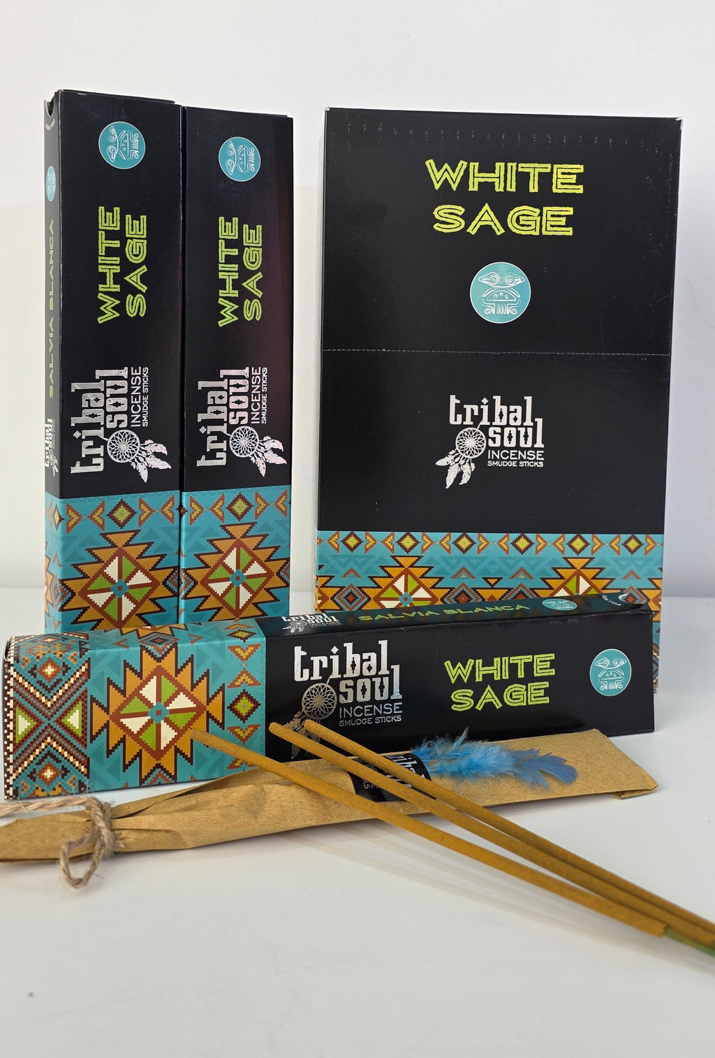 Tribal Soul white sage incense sticks main box, plus 2 packs stood next to and 1 laying down with the inner pack lay infront with 3 incense stickss resting on the inner pack,  on white background, 