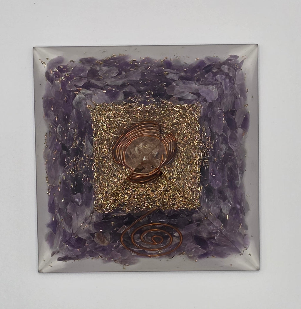 Birdseye view of amethyst orgonite pyramid 60mm showing pyramid shape, lines and crystal layers
