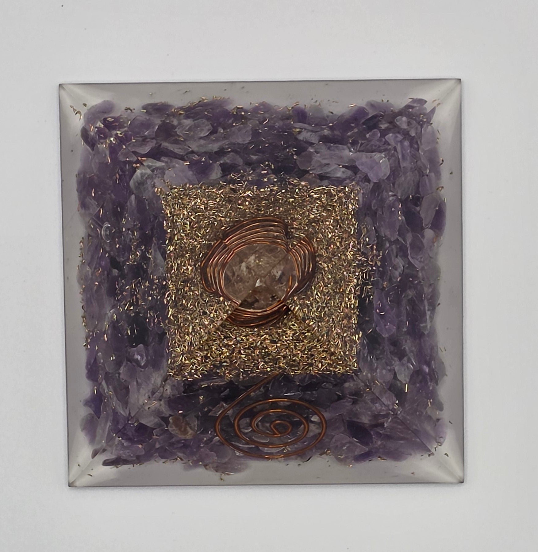 Birdseye view of amethyst orgonite pyramid 60mm showing pyramid shape, lines and crystal layers