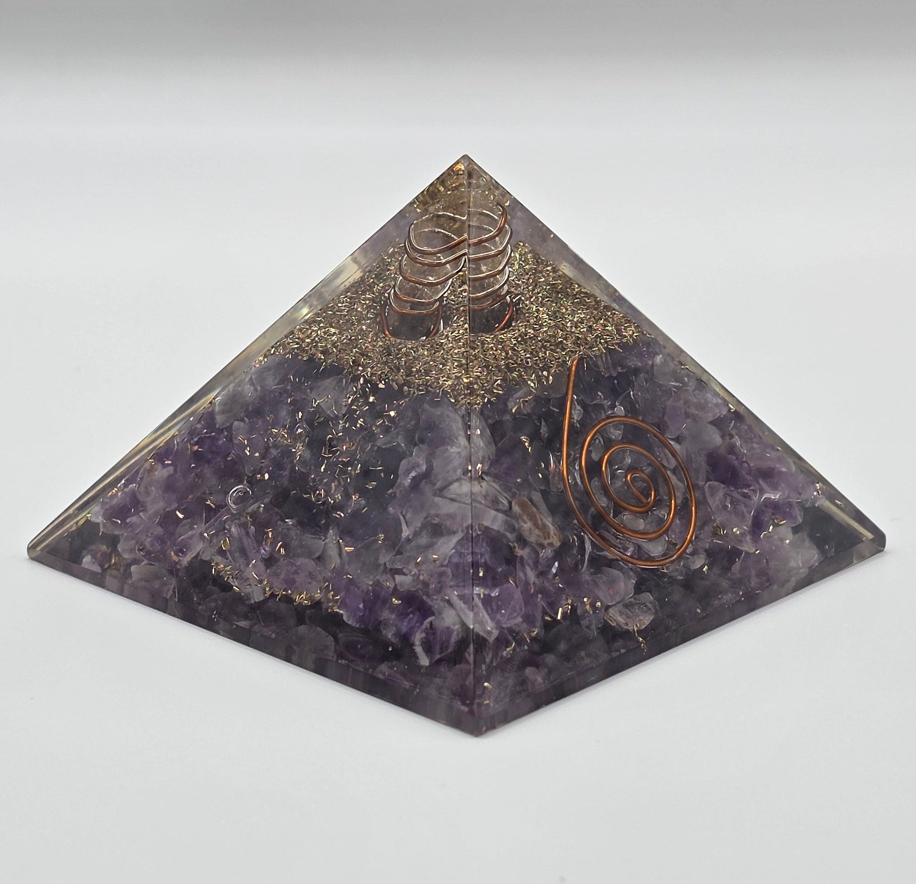 Amethyst orgonite pyramid 60mm on white background – purple crystal pyramid for calm and EMF protection