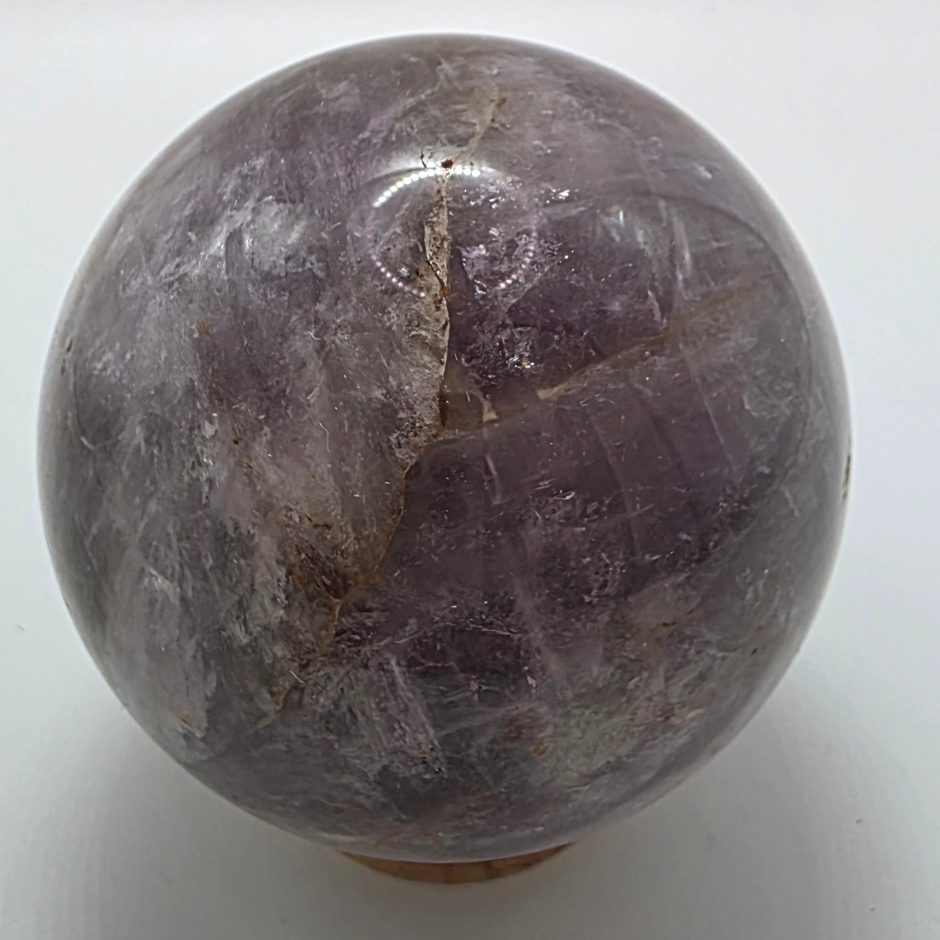 Close-up of amethyst sphere showing natural colour bands and crystal clarity