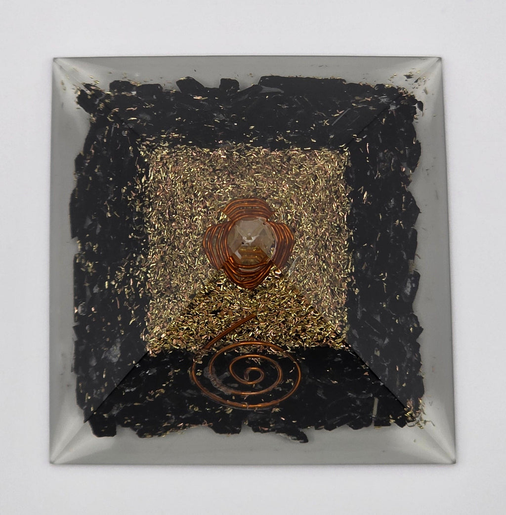Birdseye view of a Black tourmaline orgonite pyramid 60mm on white background – black crystal pyramid for protection and grounding