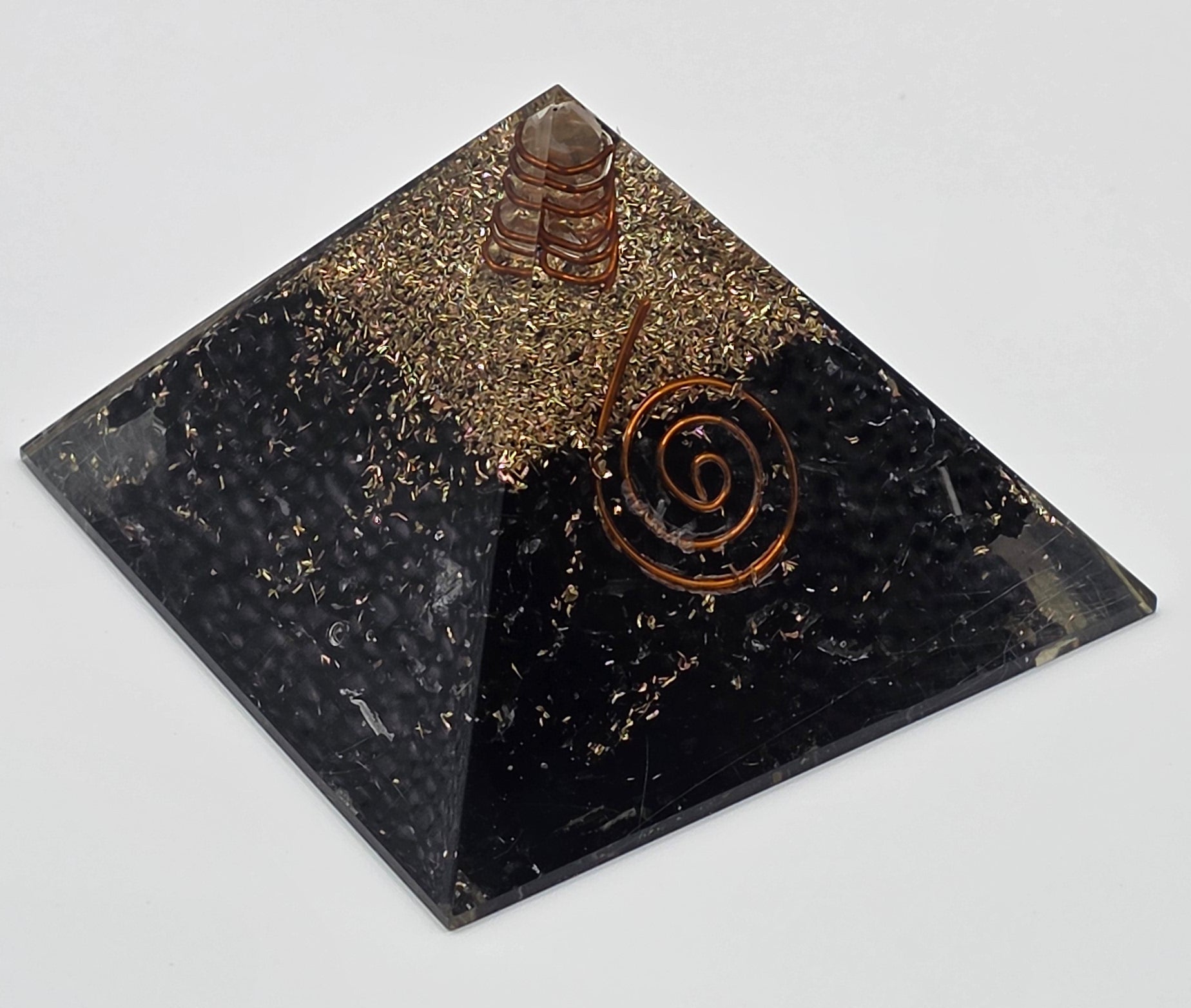 Black tourmaline orgonite pyramid 60mm on white background – black crystal pyramid for protection and grounding
