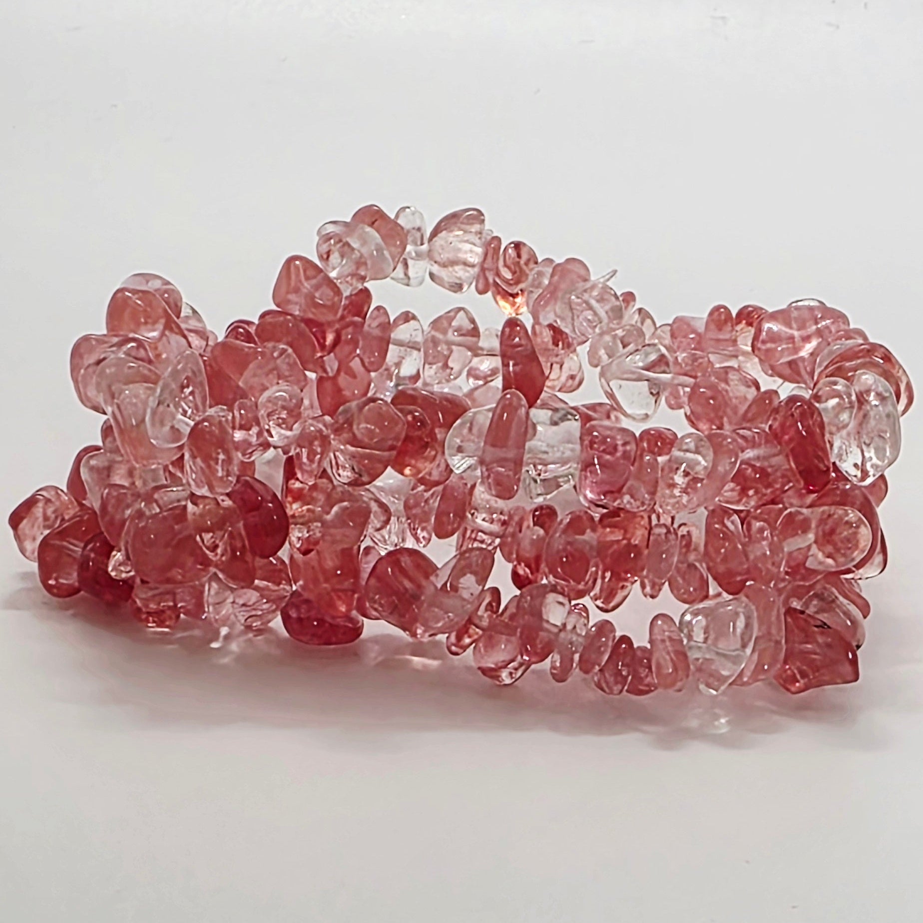 Vibrant cherry quartz chip bracelets with pink-red tones on white background