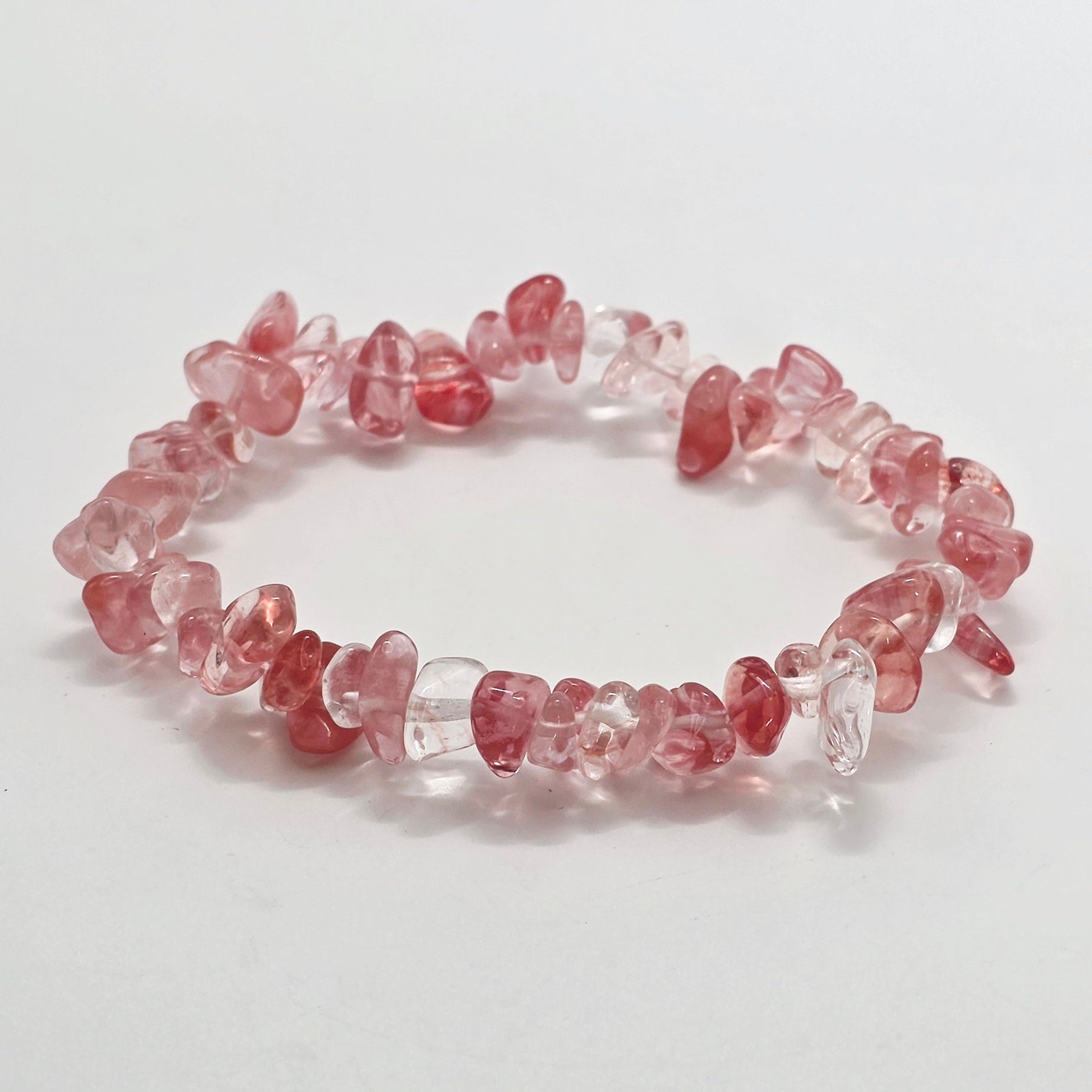 Vibrant cherry quartz chip bracelet with pink-red tones on white background