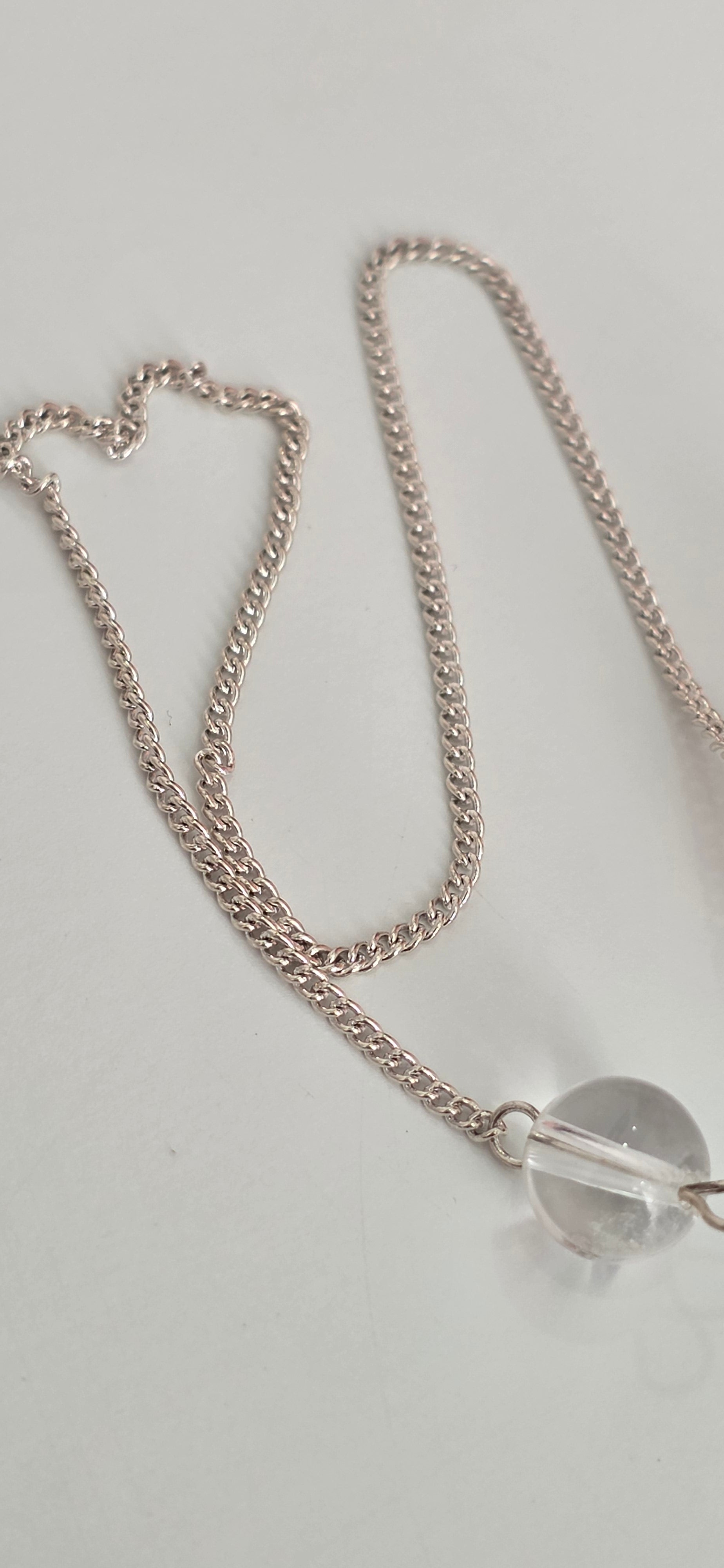 Close up of silver plated pendulum chain and clasp showing metal finish