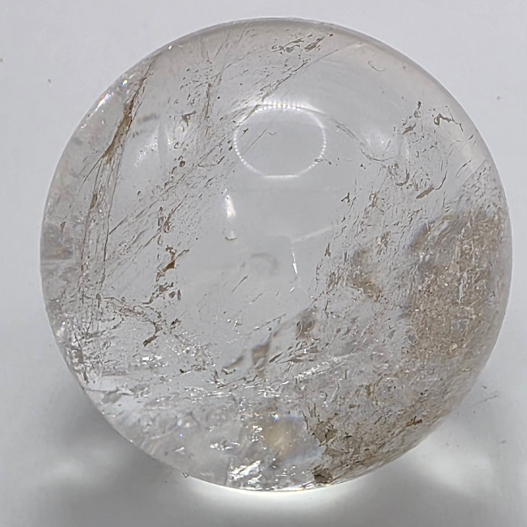 Clear quartz sphere showing natural clarity and subtle inclusions