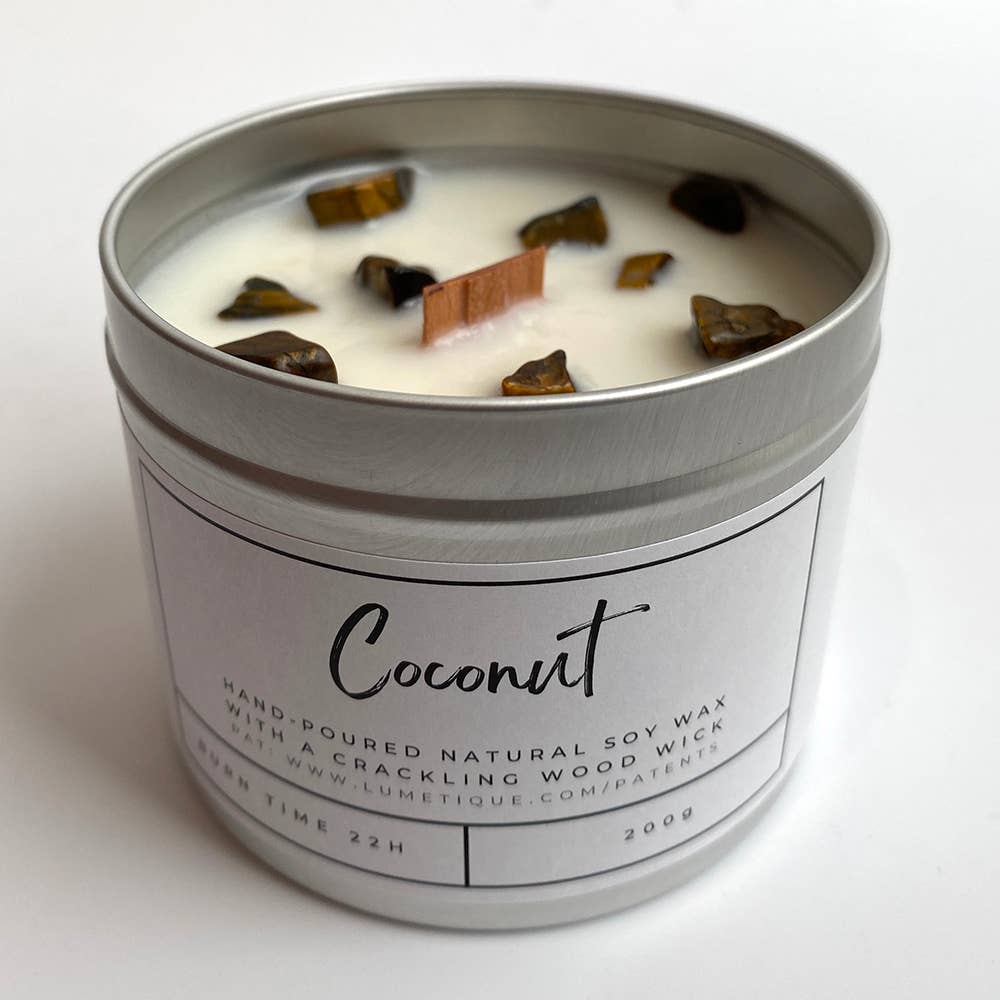 Coconut candle in aluminium tin with tiger's eye crystals and wood wick on white background