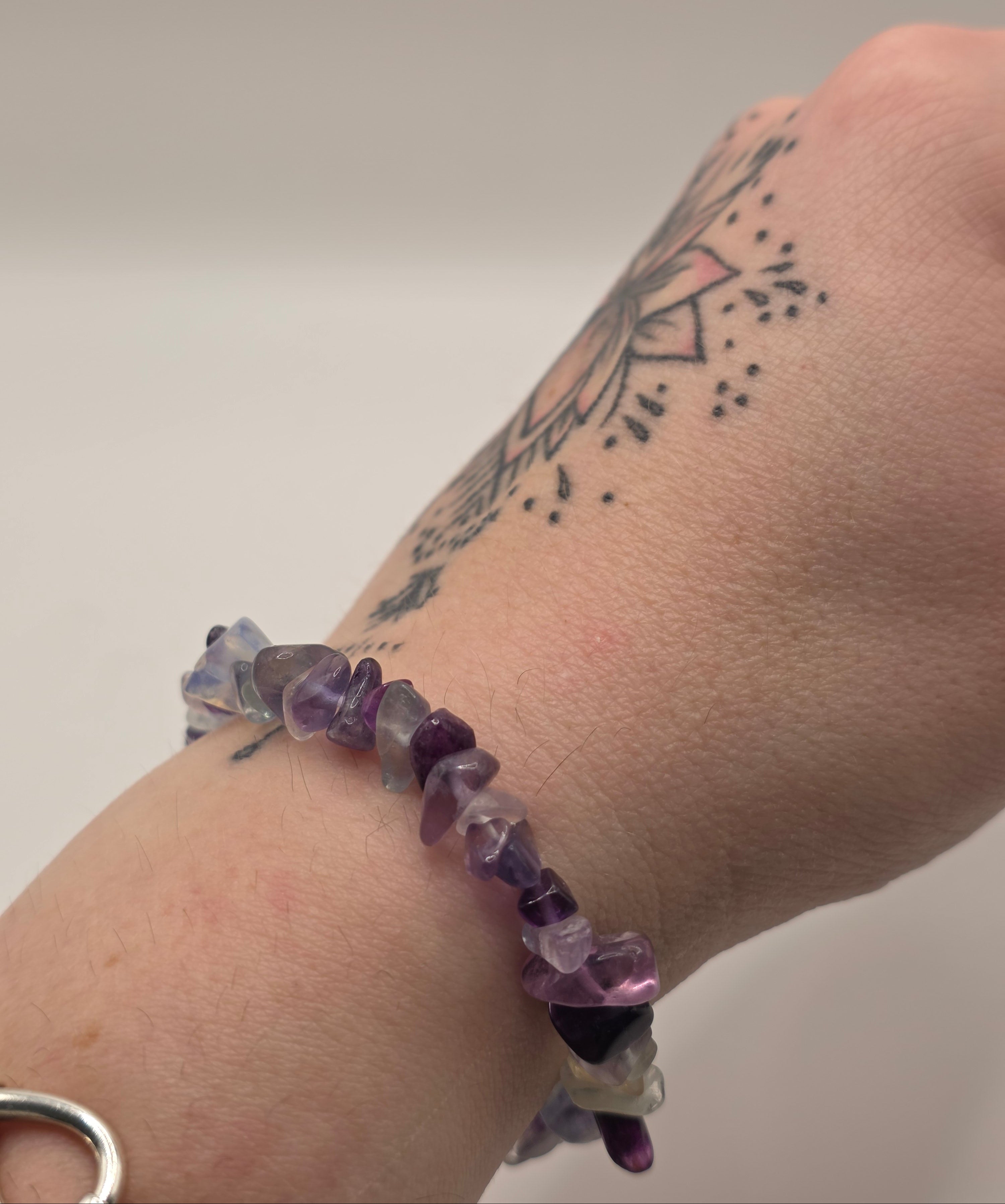 Fluorite chip bracelet worn on a wrist – double strung elastic stretch bracelet for crystal healing on the go