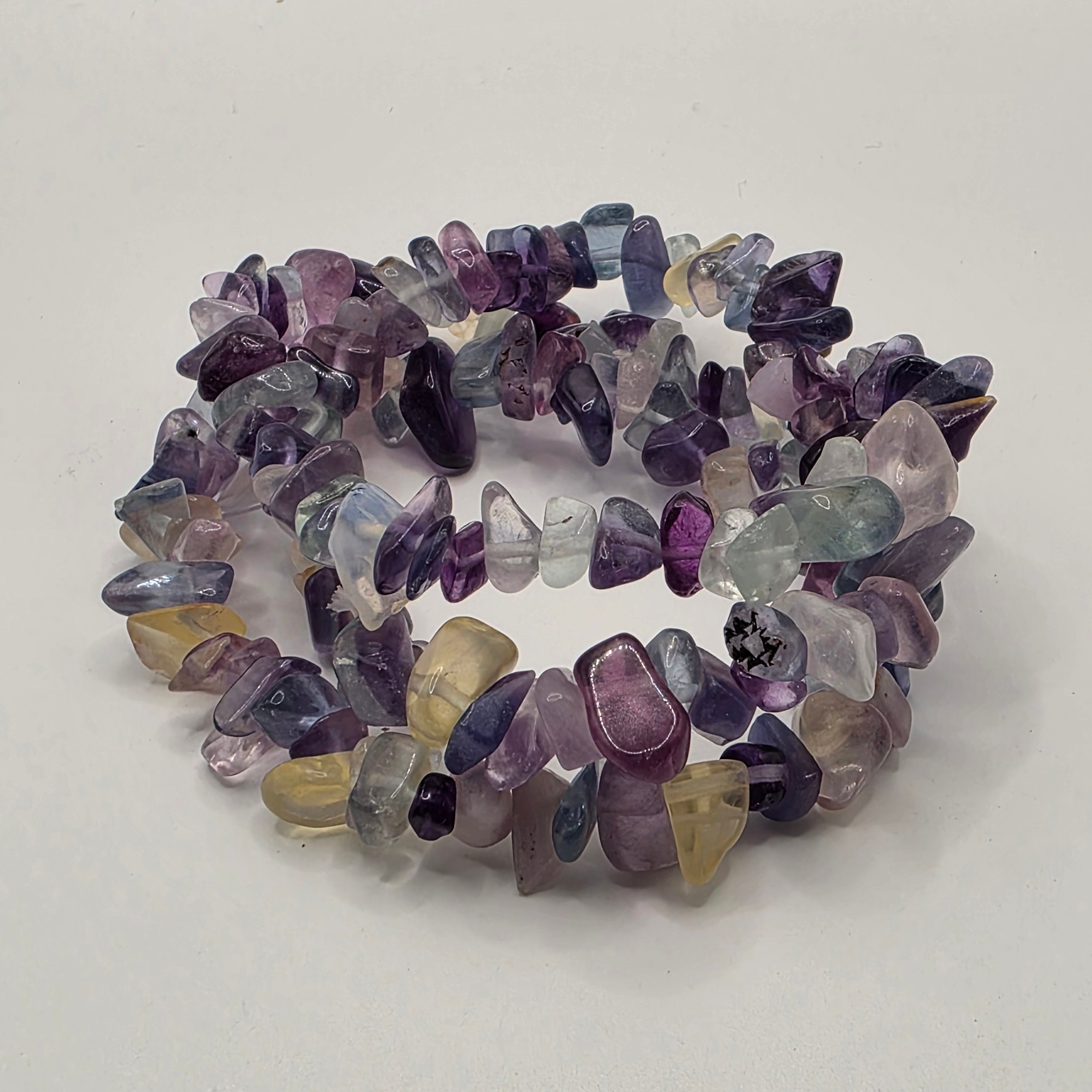 3 Fluorite chip bracelets on white background – natural purple and green gemstone chips for focus and mental clarity