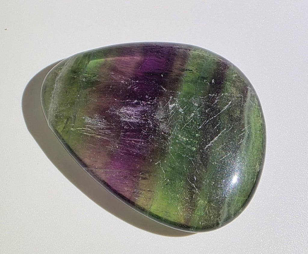Multicolored fluorite stone on a white background