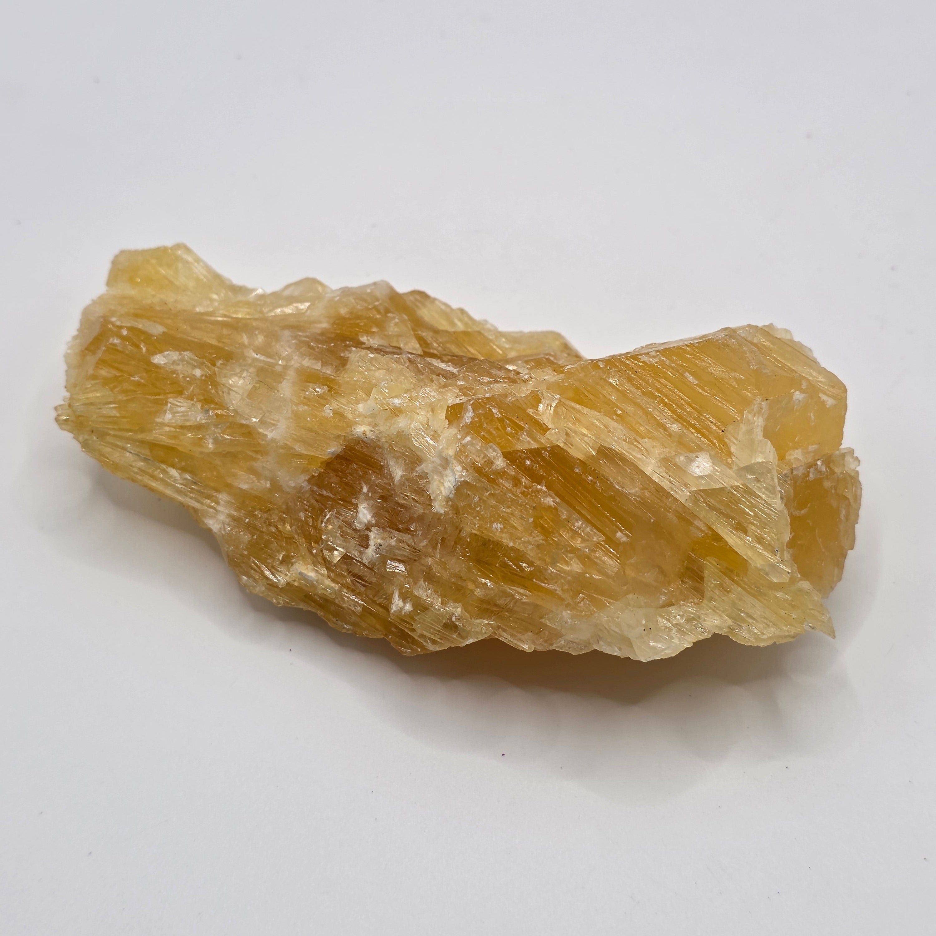 Golden calcite 222g from Afghanistan on white background – natural golden-orange crystal for abundance and manifestation
