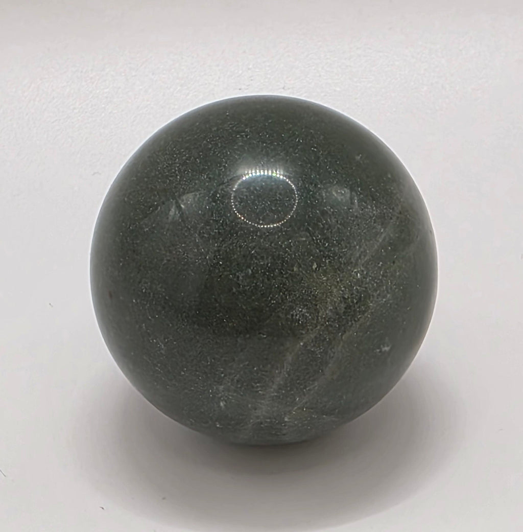 Green aventurine crystal sphere 35mm on white background – polished luck and opportunity stone