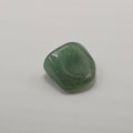 Green aventurine tumbled stone on white background – dark green crystal for luck and opportunity