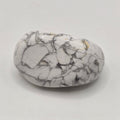 Howlite tumbled stone from South Africa on white background – natural white crystal with grey veining for calm and patience