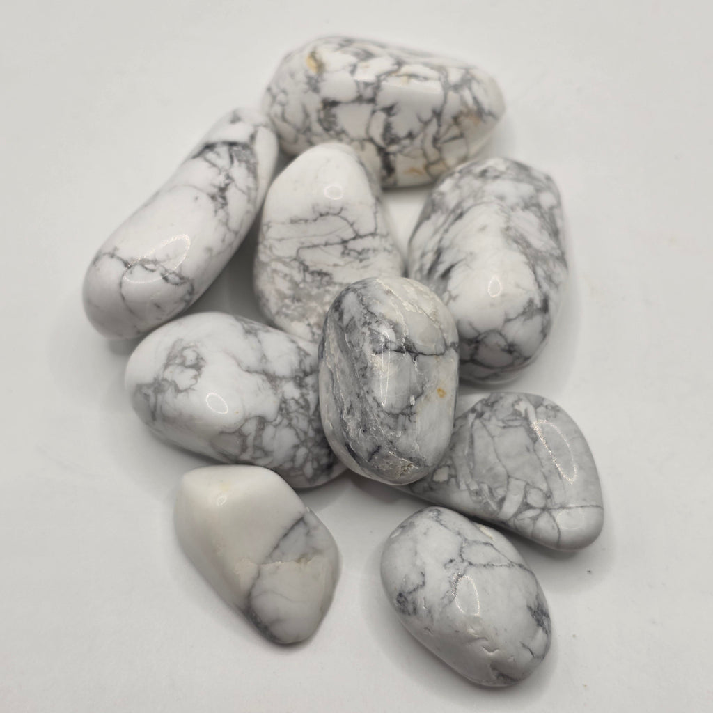Group of South African howlite tumbled stones showing natural variation in white colour and grey veining patterns