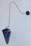 Lapis lazuli faceted pendulum with silver plated chain hanging on white background