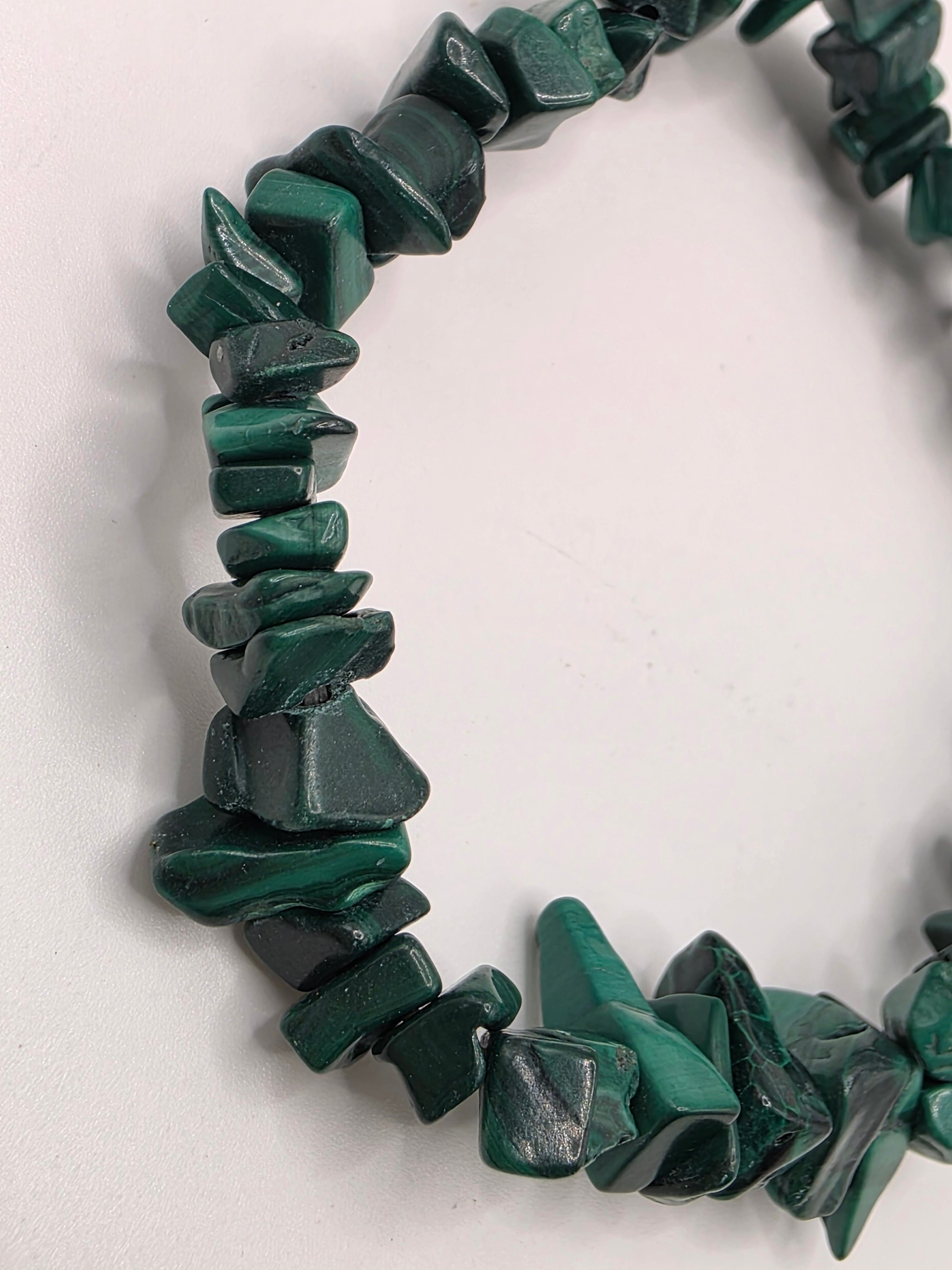 Close up of malachite chips showing rich green colour, natural banding, and swirl patterns
