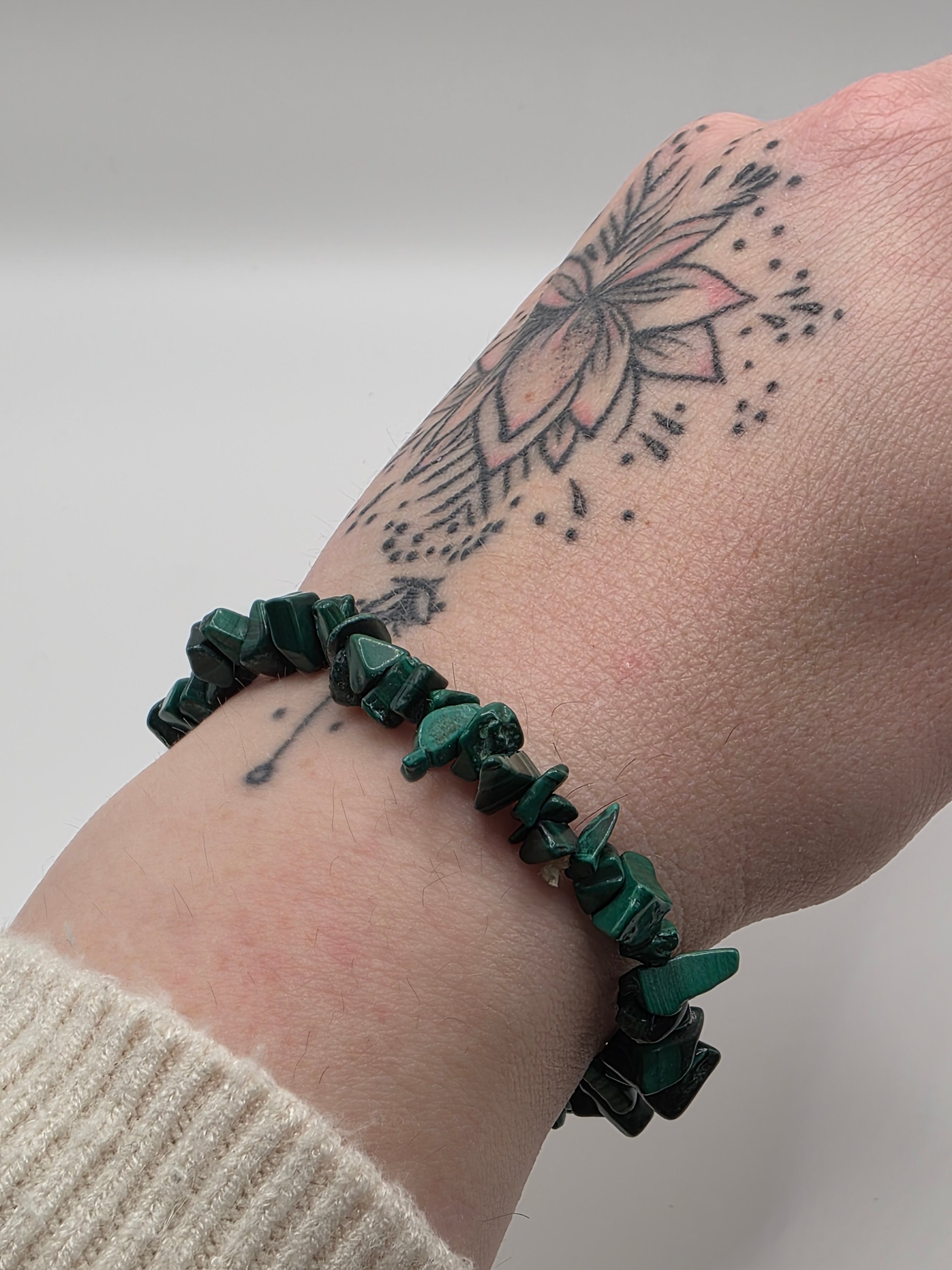 Malachite chip bracelet worn on a wrist – double strung elastic stretch bracelet for crystal healing on the go