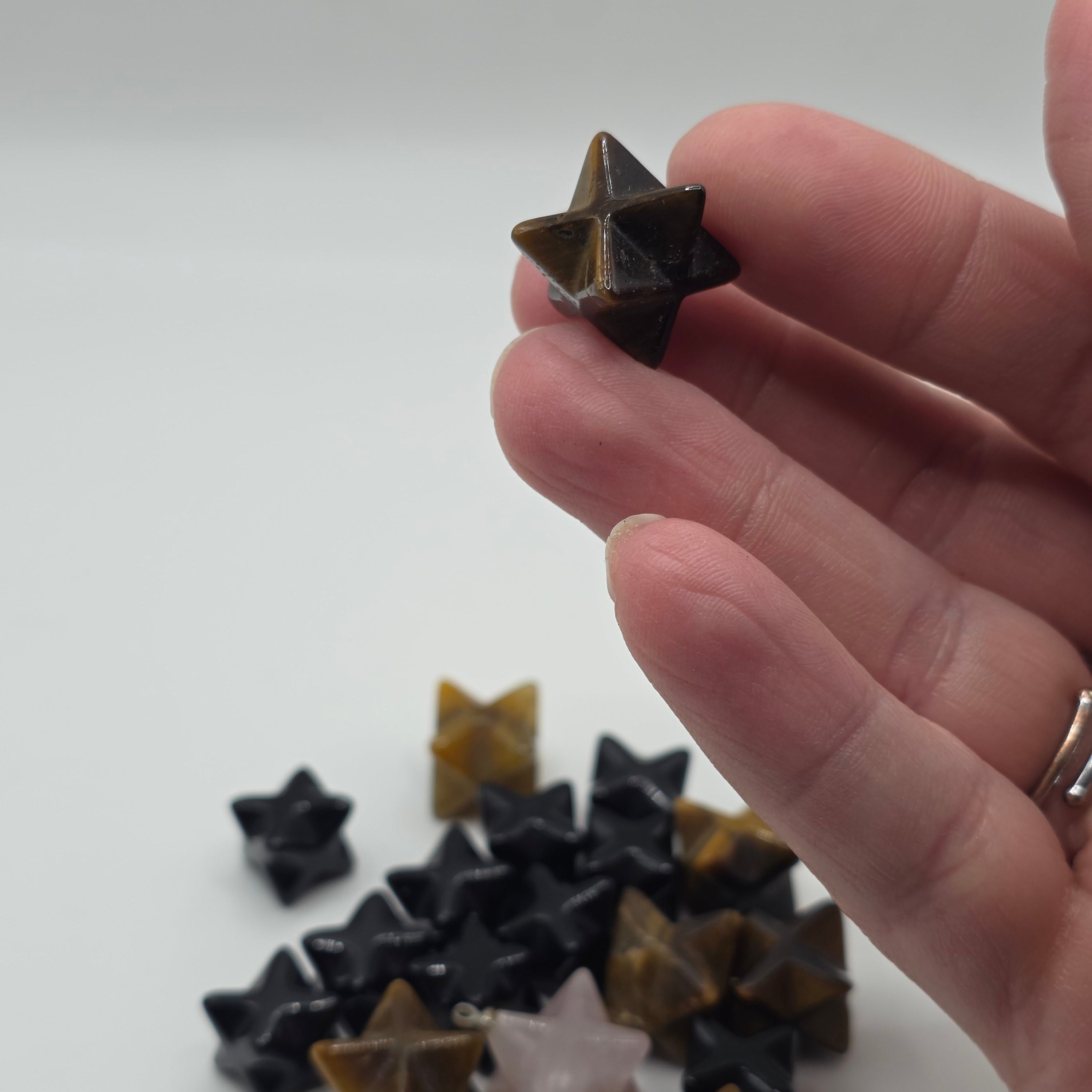 Mini merkaba star held in a person's palm – pocket-sized crystal for protection and meditation
