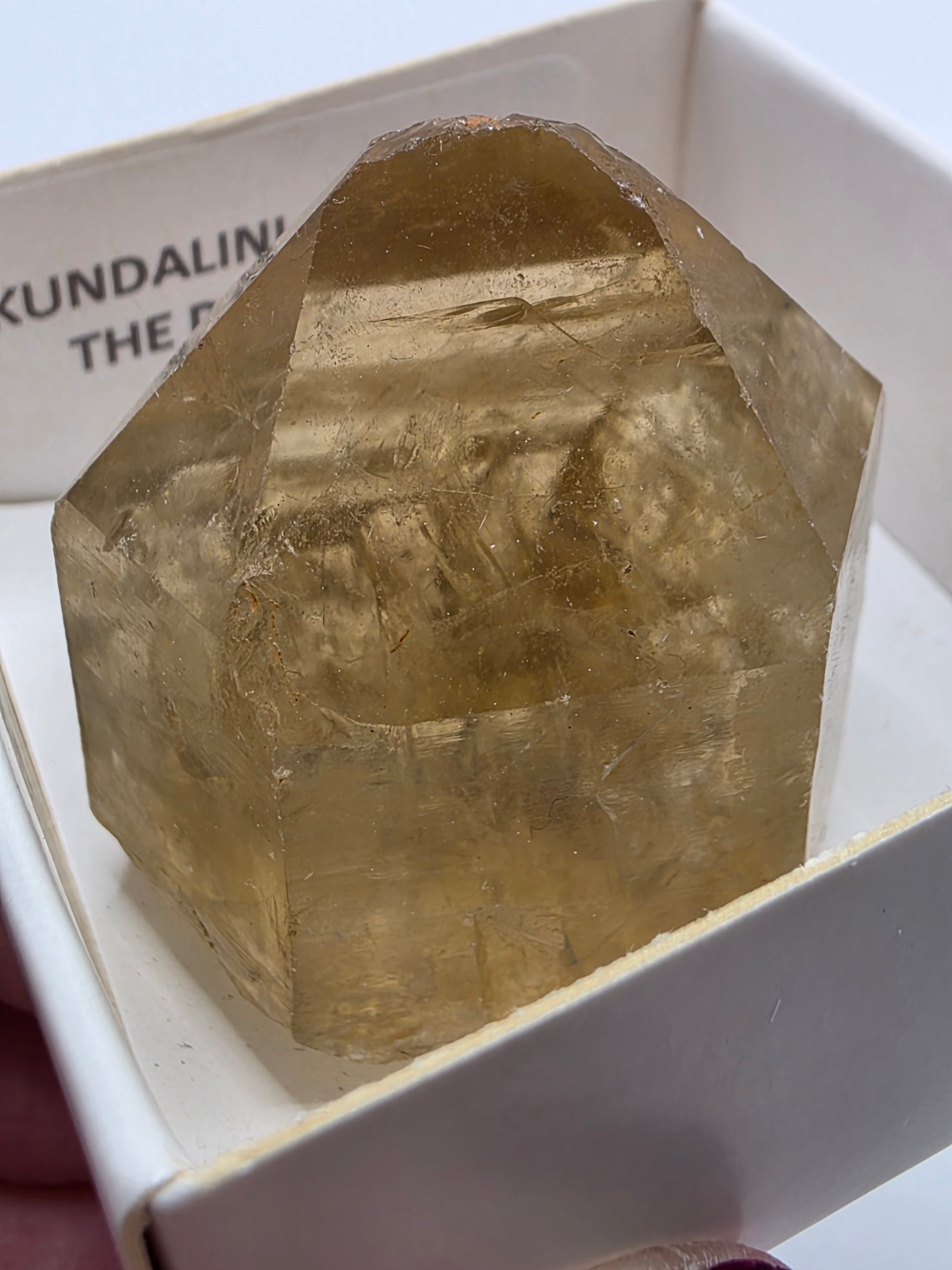 Close up of natural citrine point showing soft honey-yellow colour – genuine untreated crystal