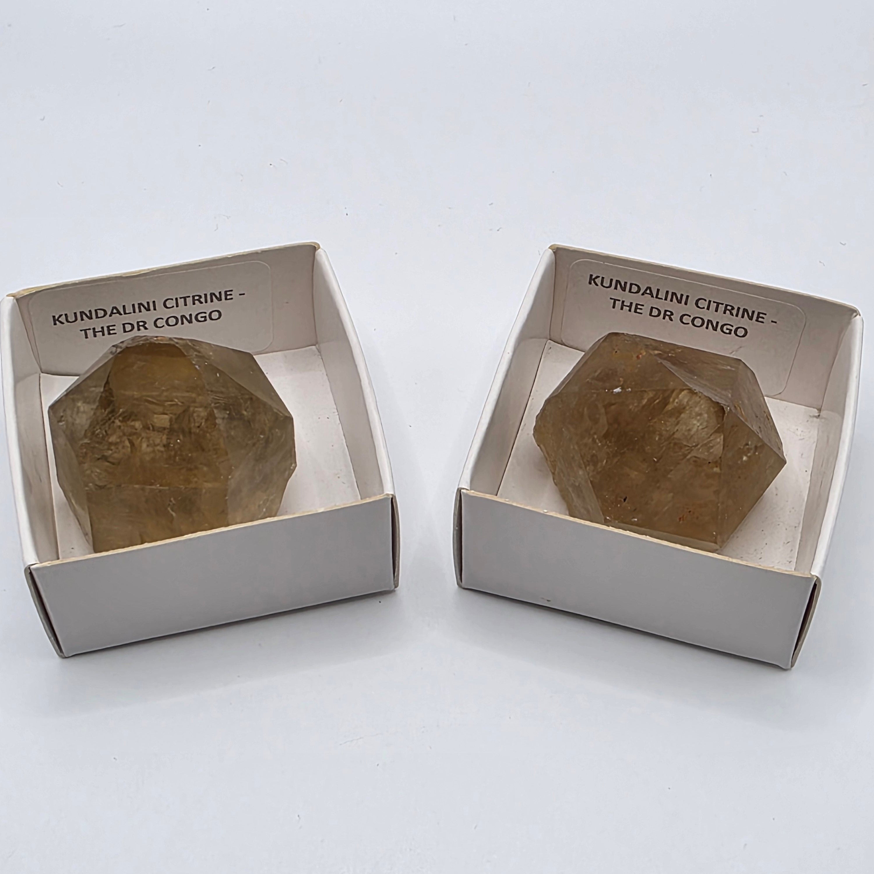 2 Natural citrine points from Congo on white background – genuine golden-yellow crystal not heat-treated