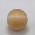 Orange calcite crystal sphere 35mm on white background – natural matte finish stone for creativity and vitality