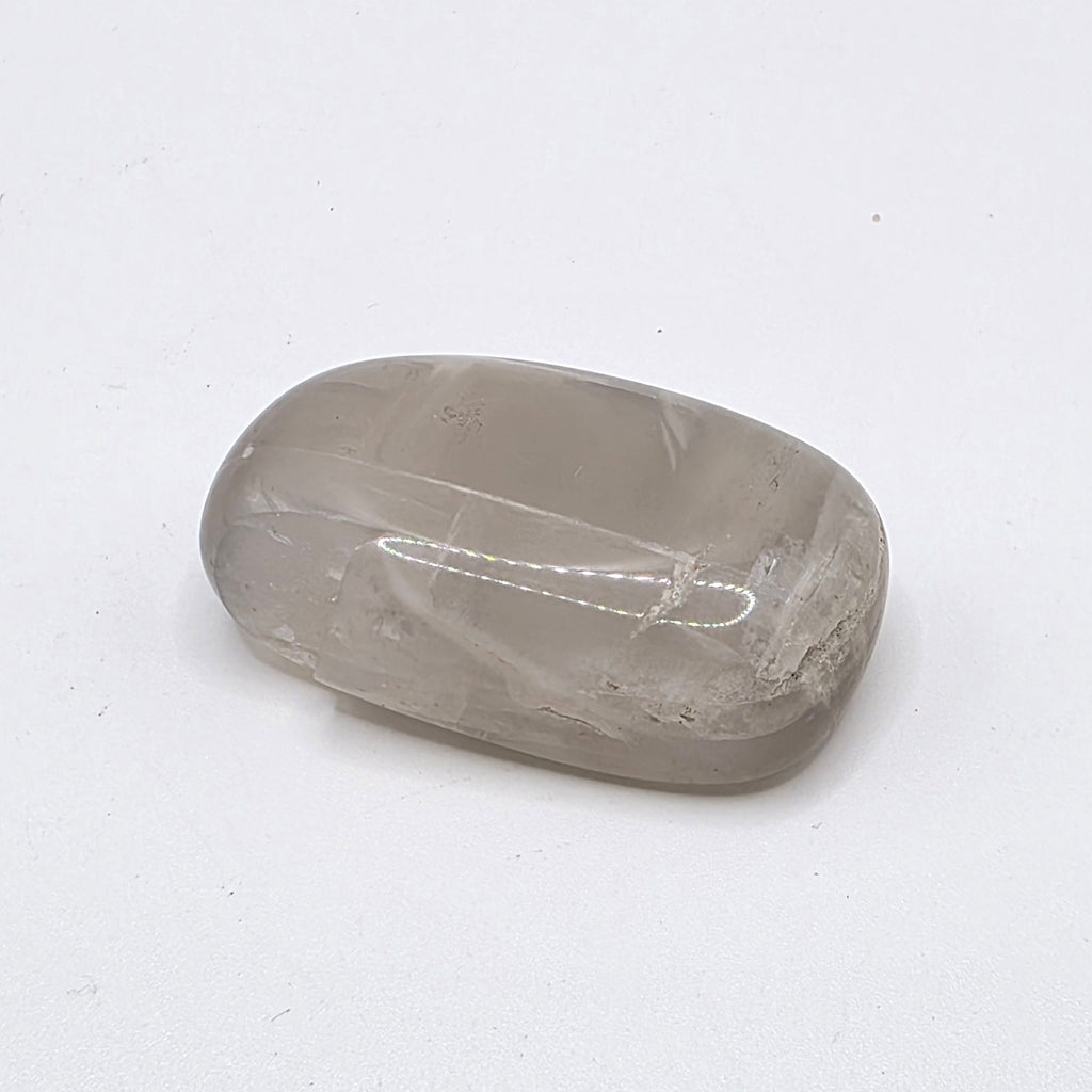 Pastel moonstone tumbled stone on white background – soft pink, peach and milky white crystal for intuition and new beginnings