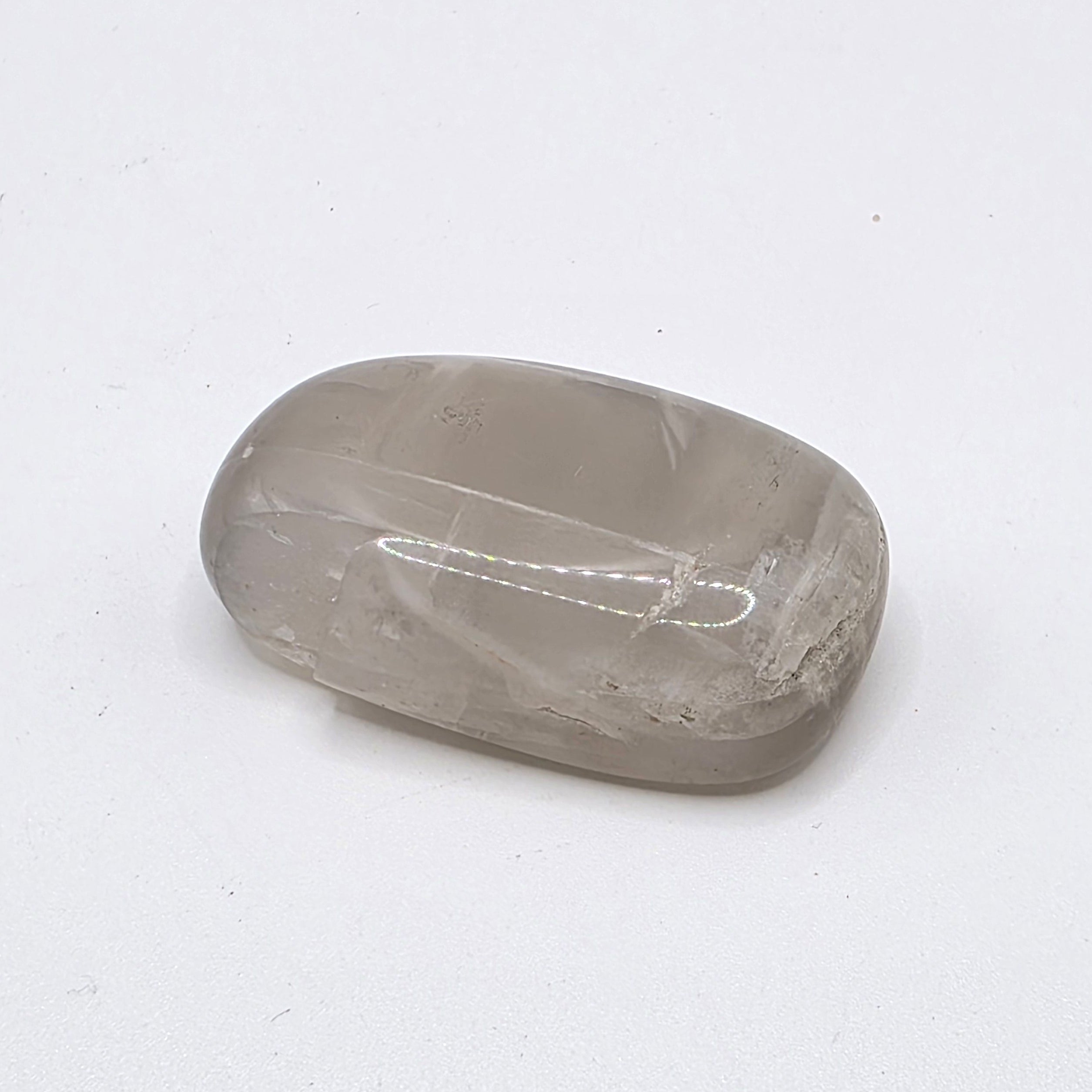 Pastel moonstone tumbled stone on white background – soft pink, peach and milky white crystal for intuition and new beginnings
