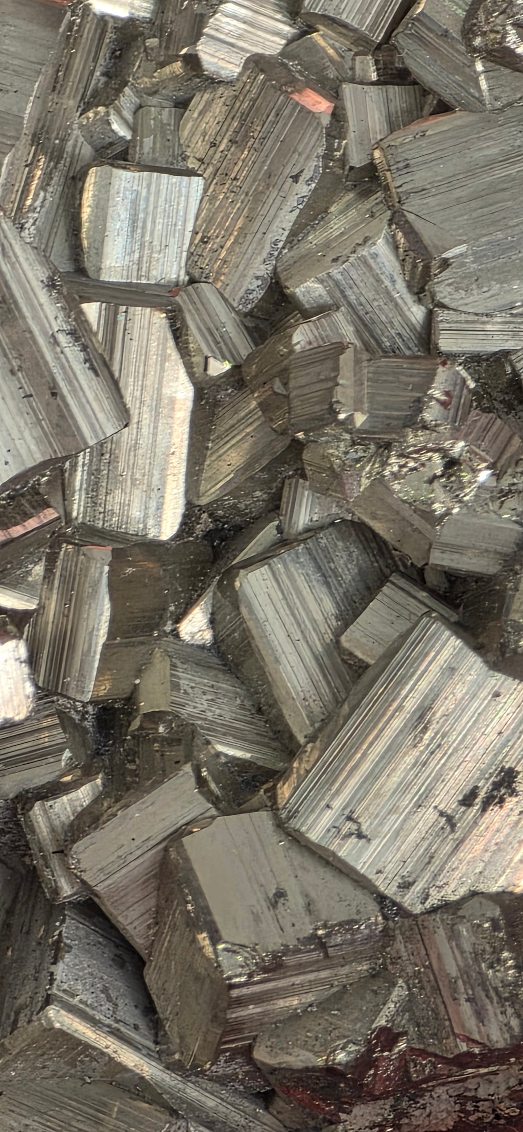 Close up of natural pyrite chispa cluster showing interlocking cubic crystal formations and metallic gold, silver colour
