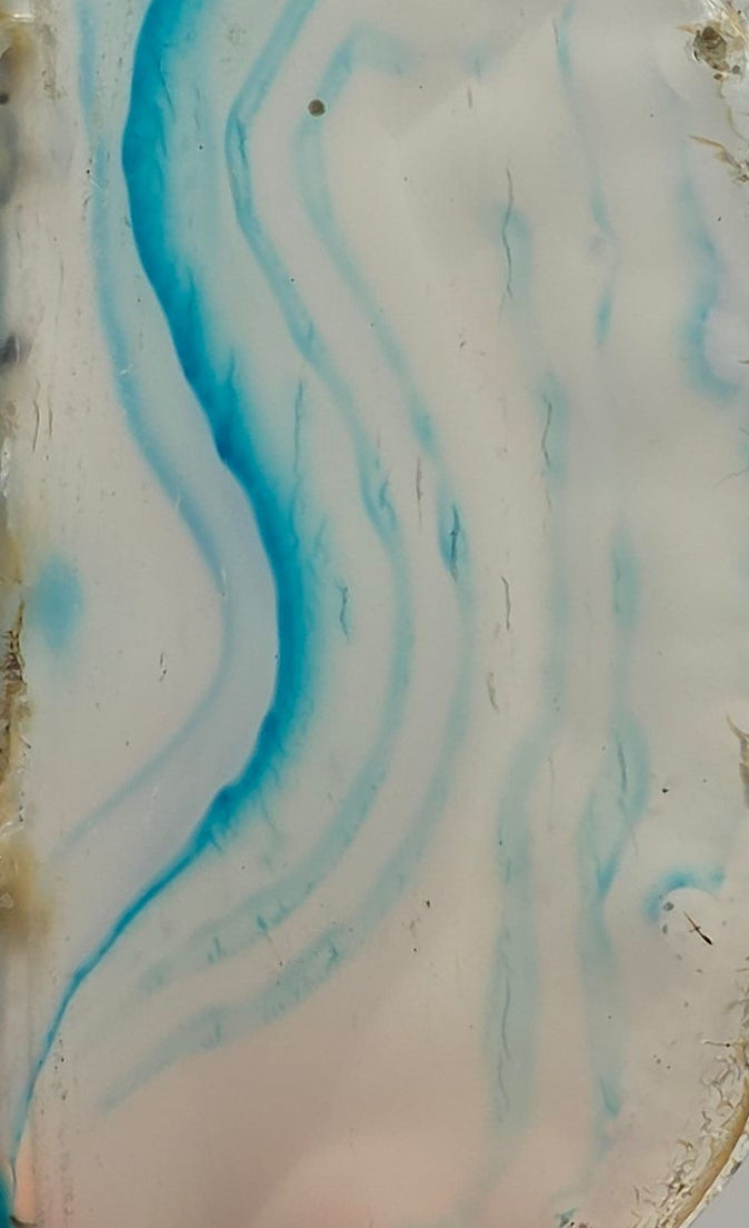 Close up of agate slice showing blue bands – vibrant dyed agate