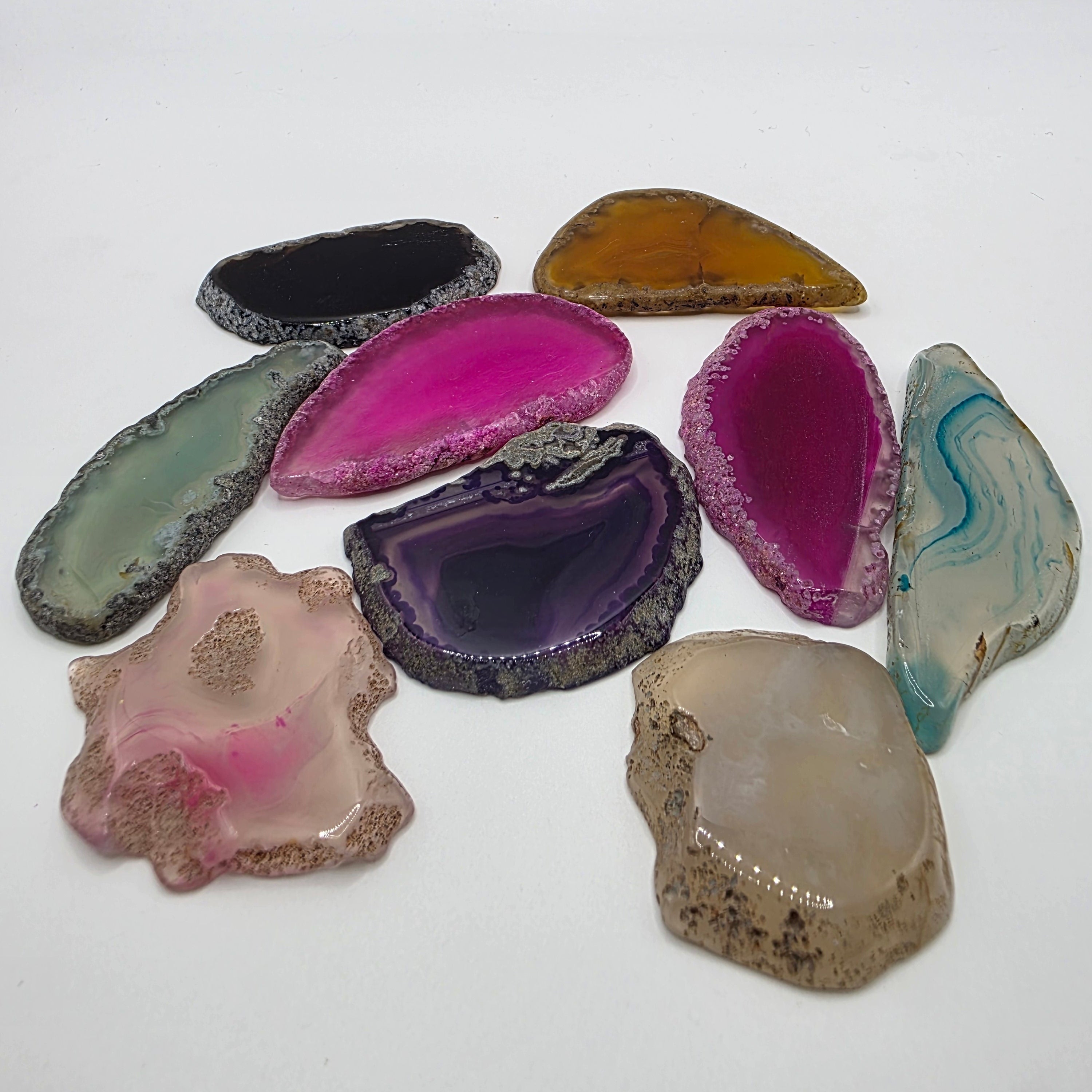 Group of rainbow agate slices showing variety of colours and shapes – mystery assortment