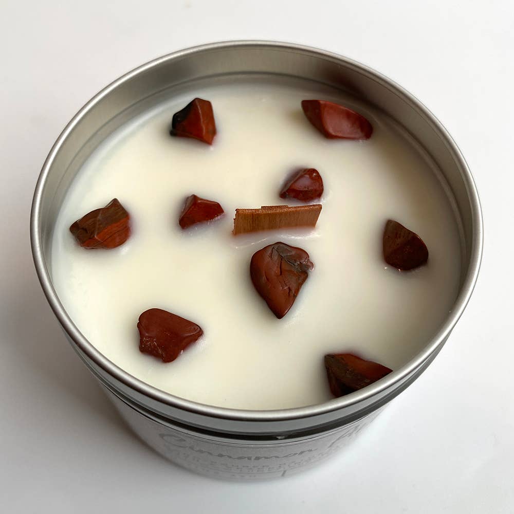 Close-up of genuine red jasper gemstone chips embedded in natural soy wax candle
