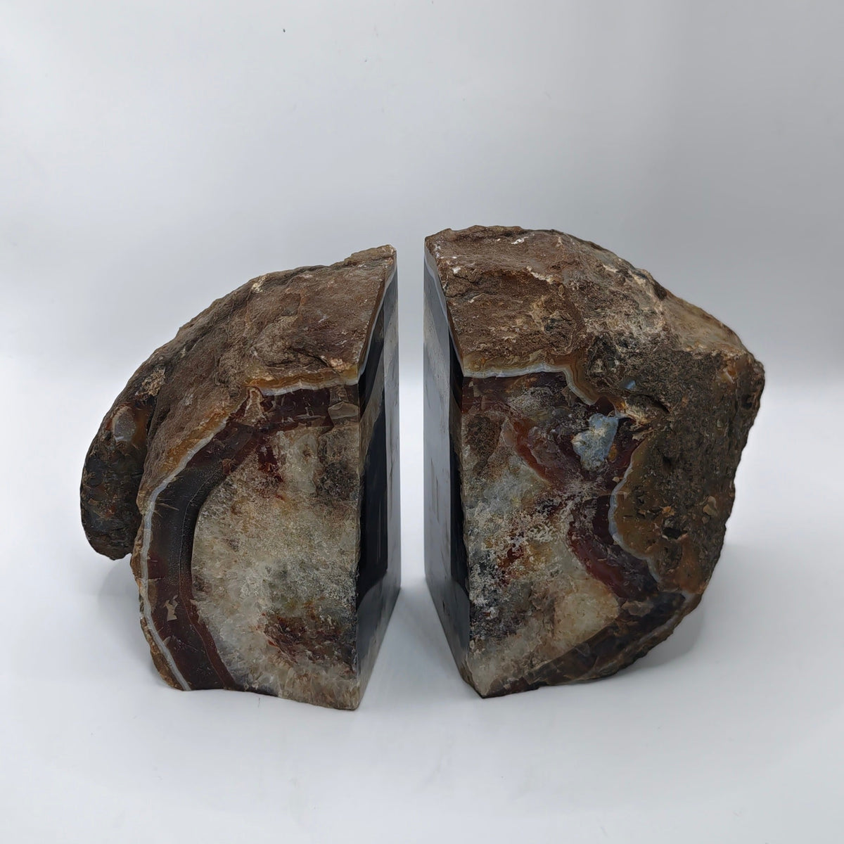 Rear of bookends, featuring natural brown, beige, and gray patterns, standing upright on a white background.