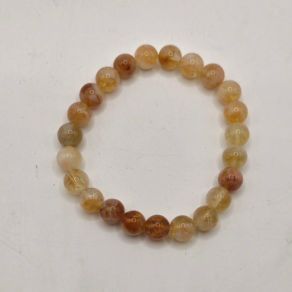 A premium citrine beaded stretch bracelet, photographed on a plain off-white surface.