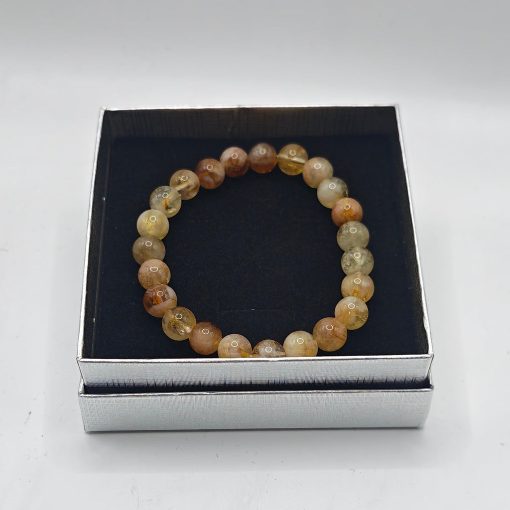 A premium citrine beaded bracelet displayed inside an open presentation box with a silver base on a  white background.