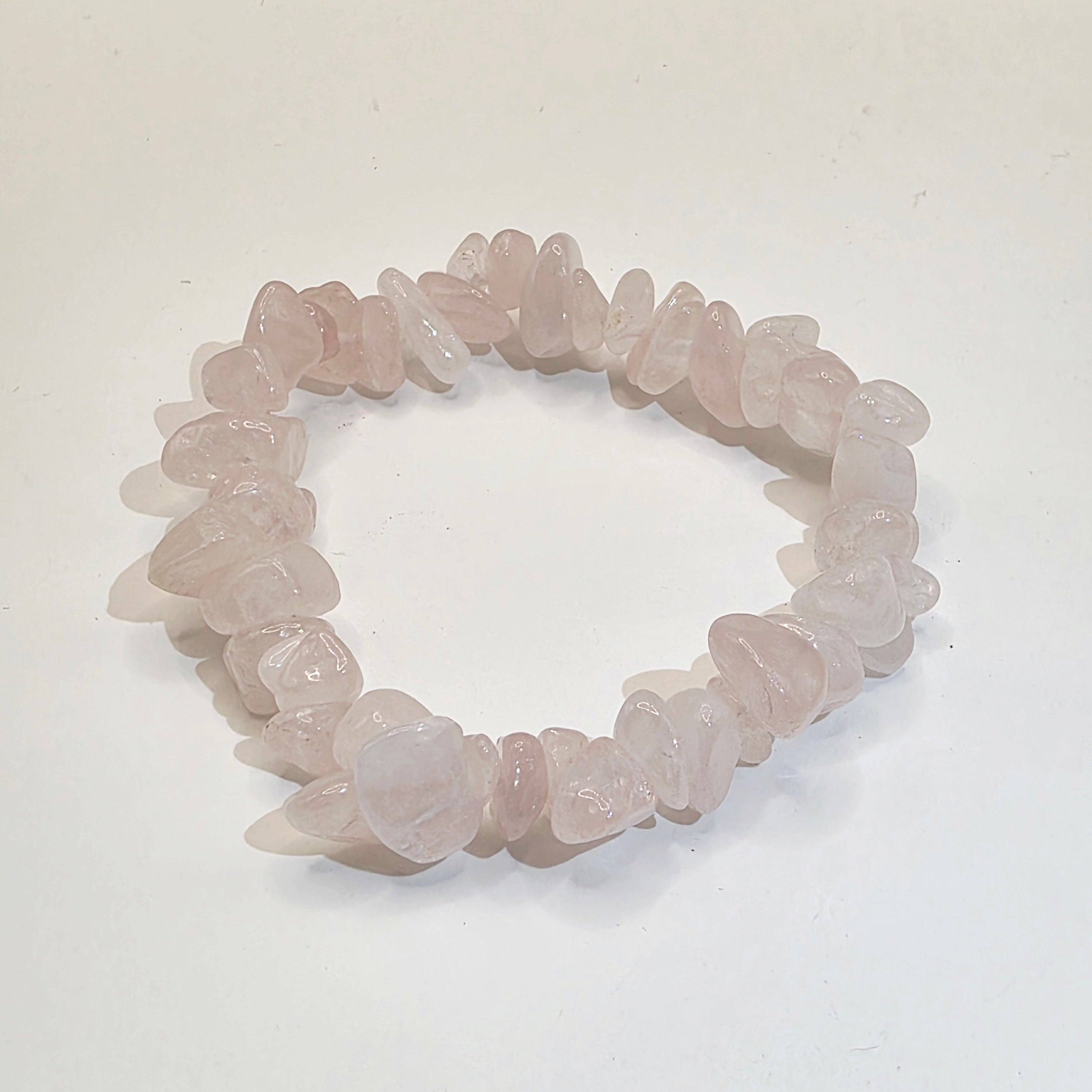 Rose quartz chip bracelet on white background – natural pink gemstone chips for self-love and heart healing