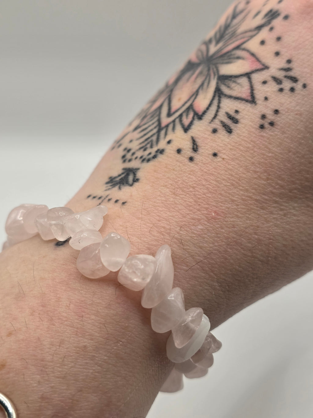 Rose quartz chip bracelet worn on a wrist – double strung elastic stretch bracelet for crystal healing on the go