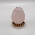 Polished 45mm rose quartz crystal egg on white background